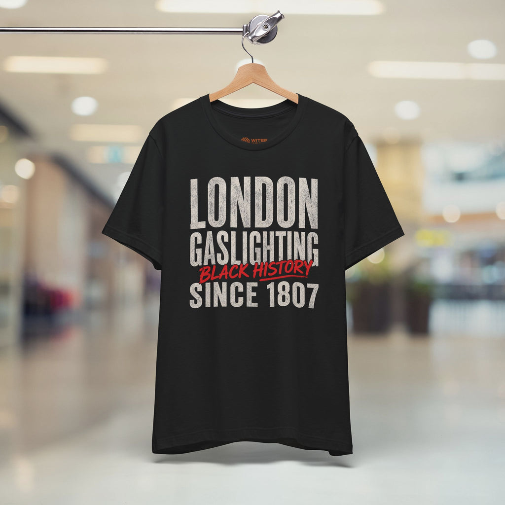 Navy blue t-shirt with humorous text design on a hanger in a mall setting