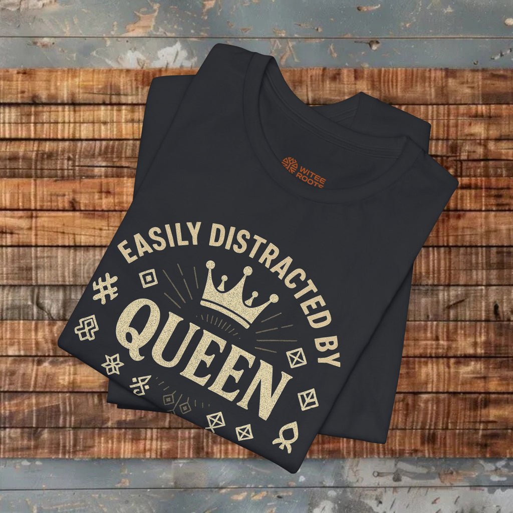 Black t-shirt with 'Easily Distracted by Queen' text on a wooden surface