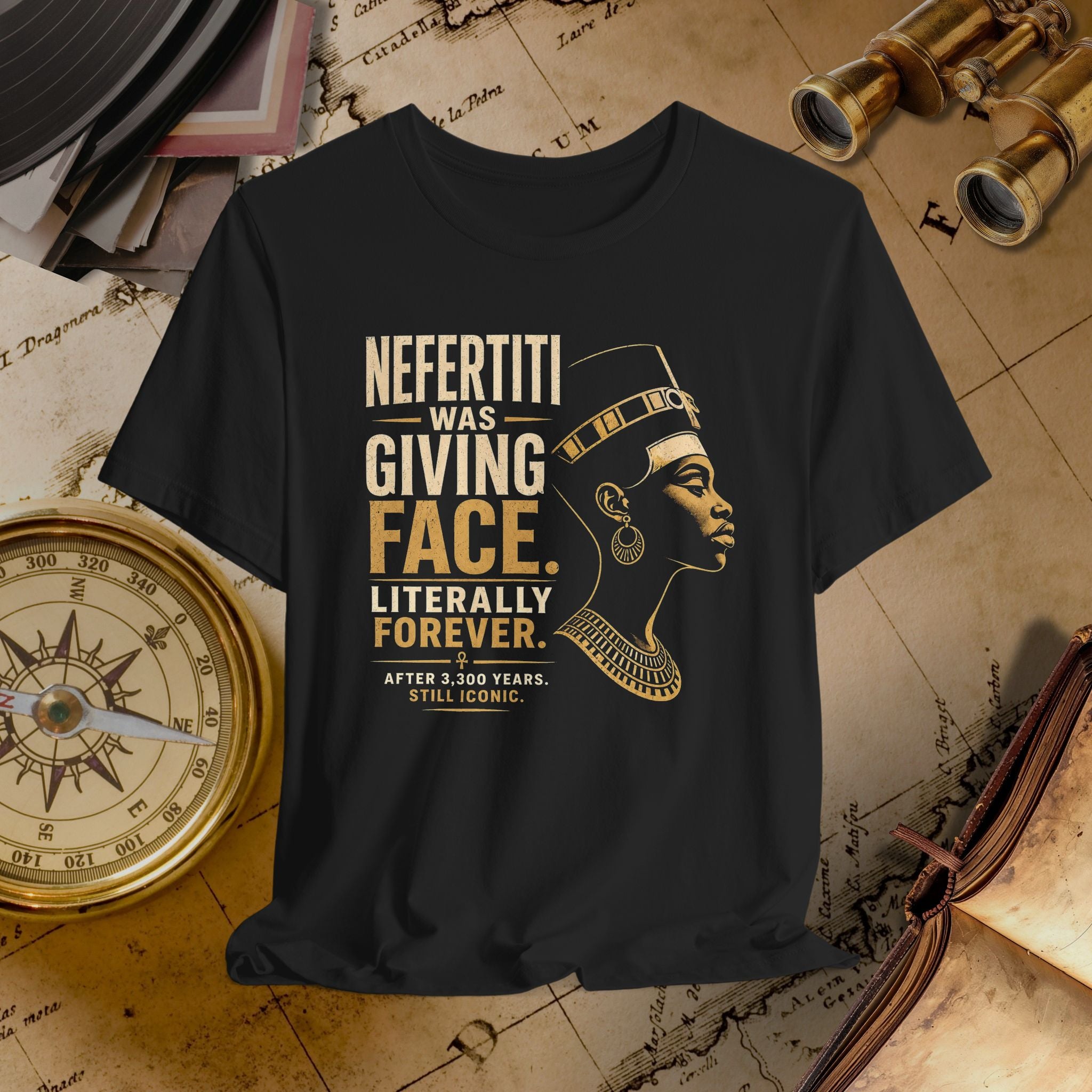 Black t-shirt with gold text and graphic of a historical figure on a vintage map background.