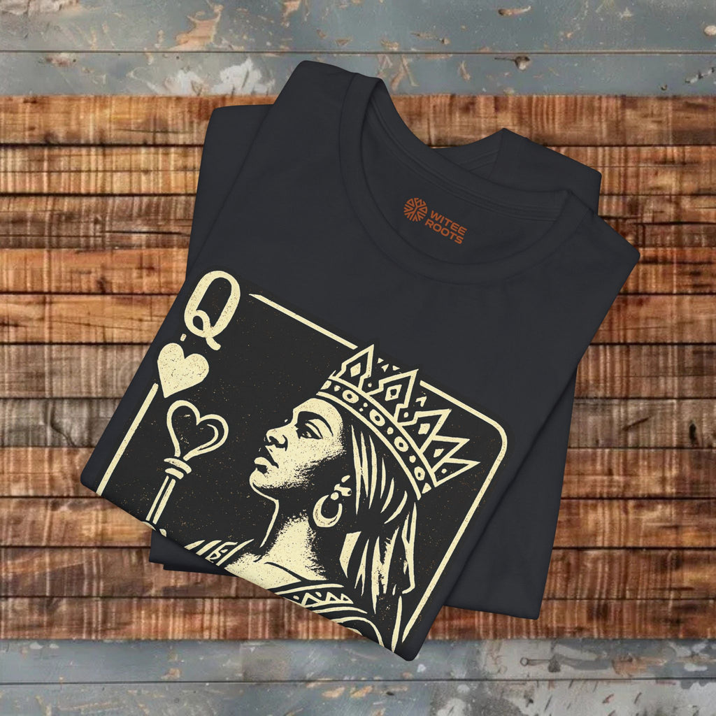 Black t-shirt with a graphic design of a woman holding a heart and the letter 'Q' on a wooden surface.