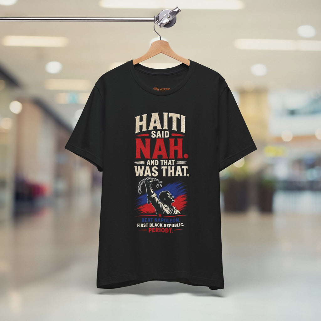 Black t-shirt with text and graphic on a hanger in a store setting
