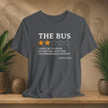 Gray t-shirt with a quote about Rosa Parks on a wooden surface with plants and a patterned wall in the background