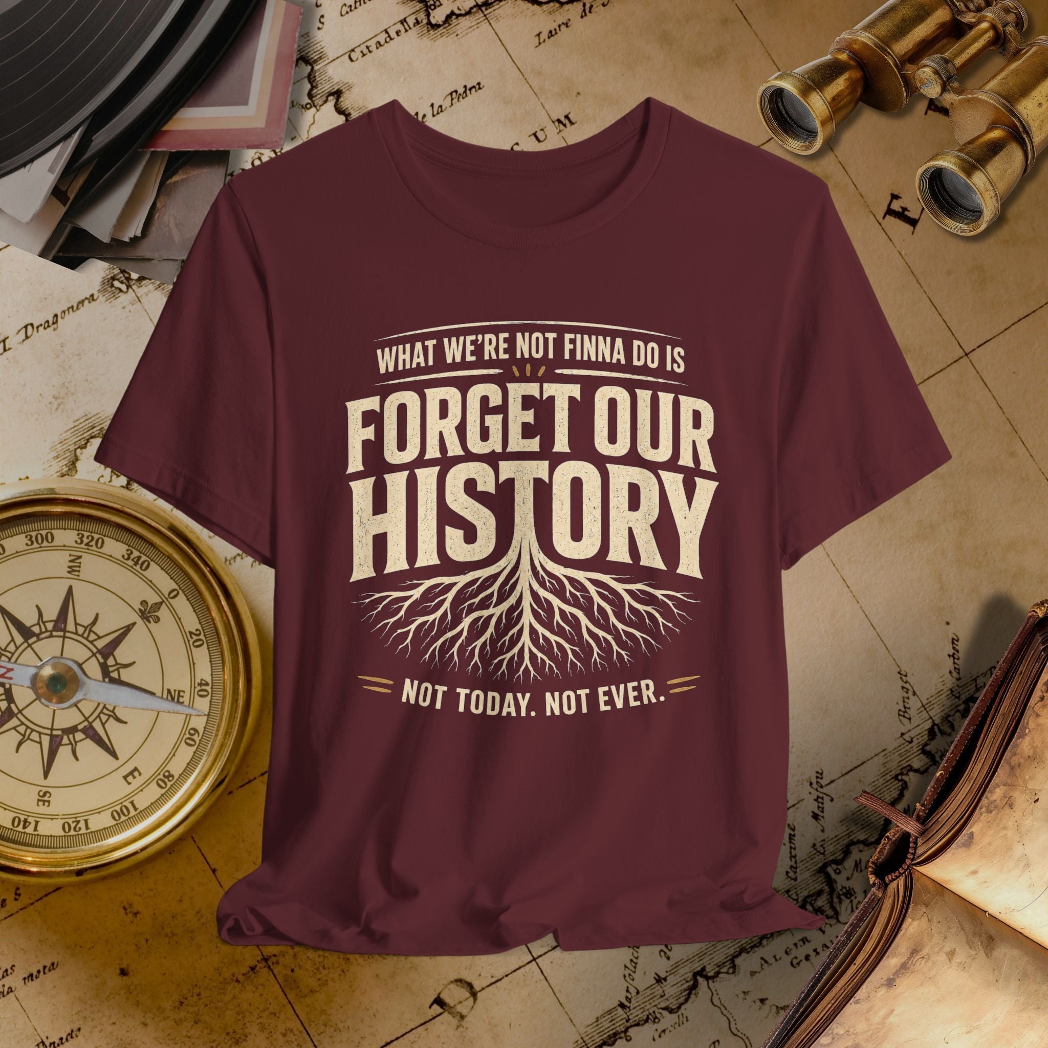 Maroon t-shirt with 'Forget Our History' text on a vintage map background