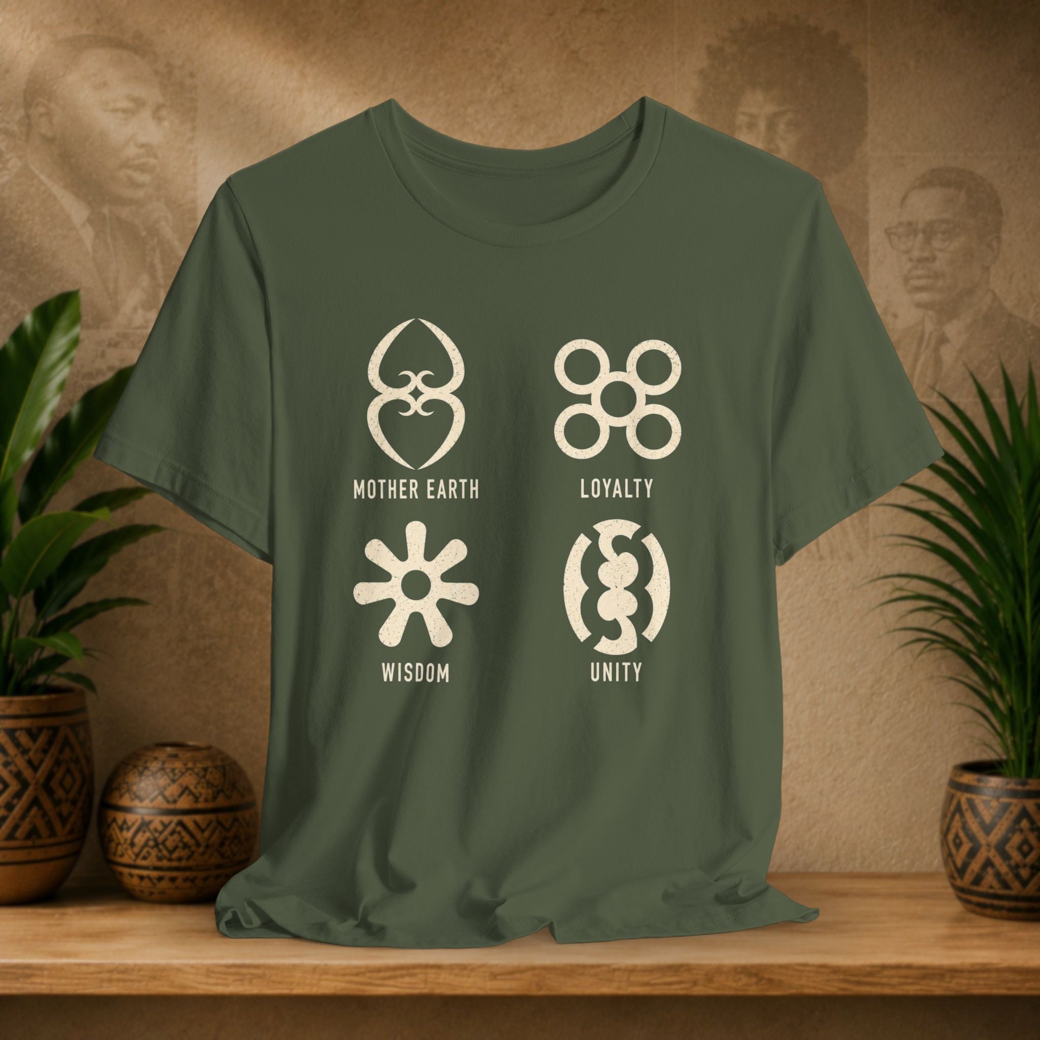 Green t-shirt with symbols and text on a wooden surface with plants and a textured wall background