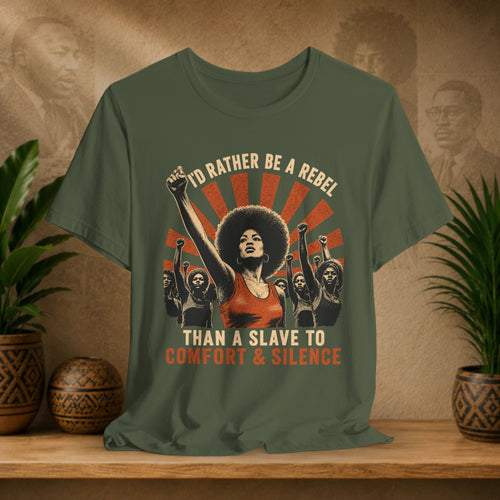 Green t-shirt with graphic design and text on a wooden surface with plants and decorative items.