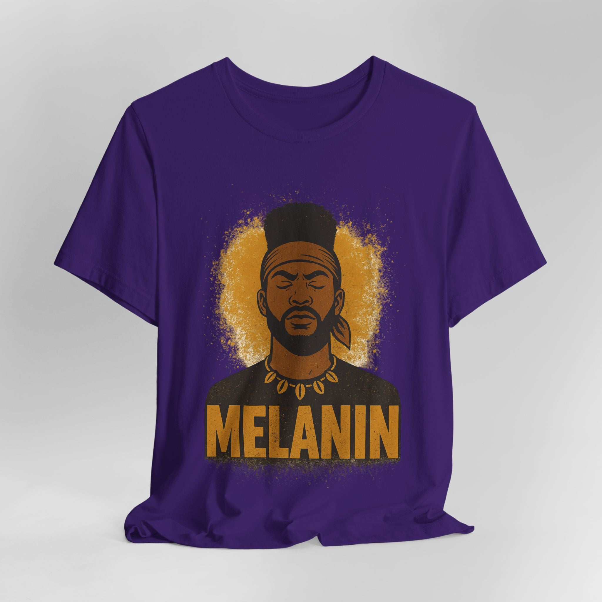Purple t-shirt with a graphic of a man's face and the word 'Melanin' on a gray background