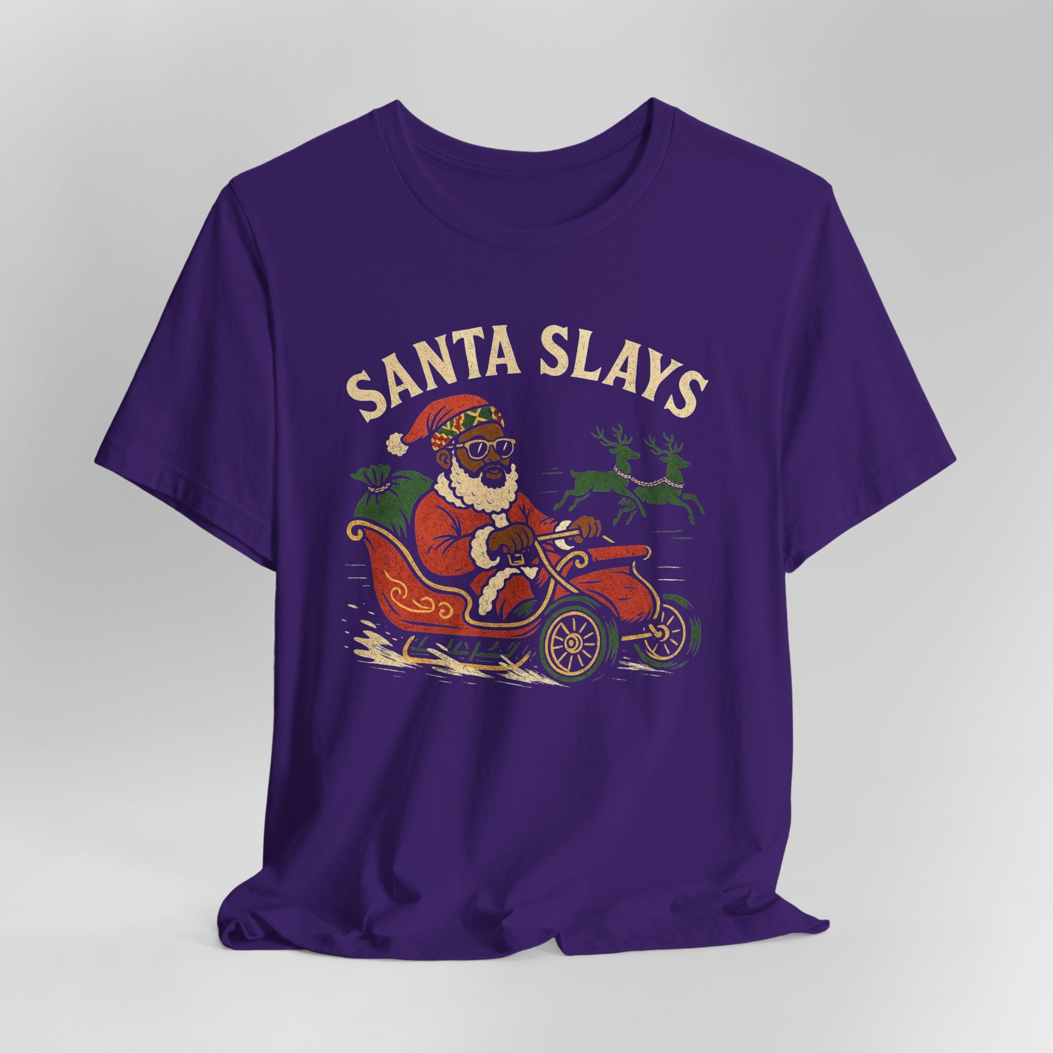 Purple t-shirt with a graphic of Santa driving a car and the text 'Santa Slays' on a gray background.