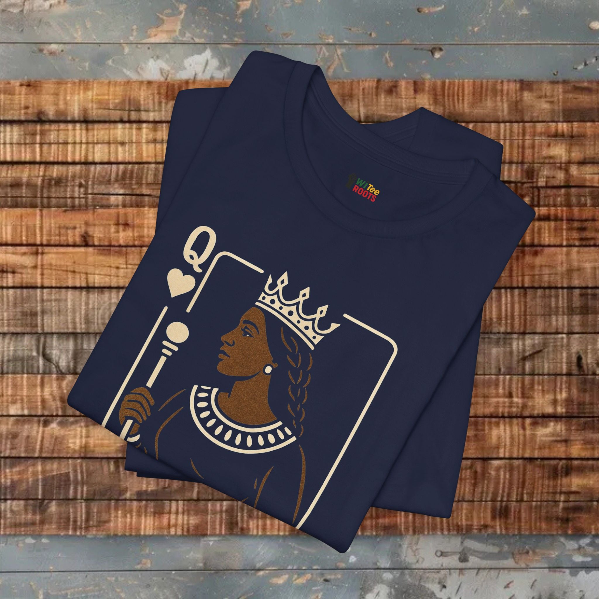 Folded navy t-shirt with a graphic design on a wooden surface
