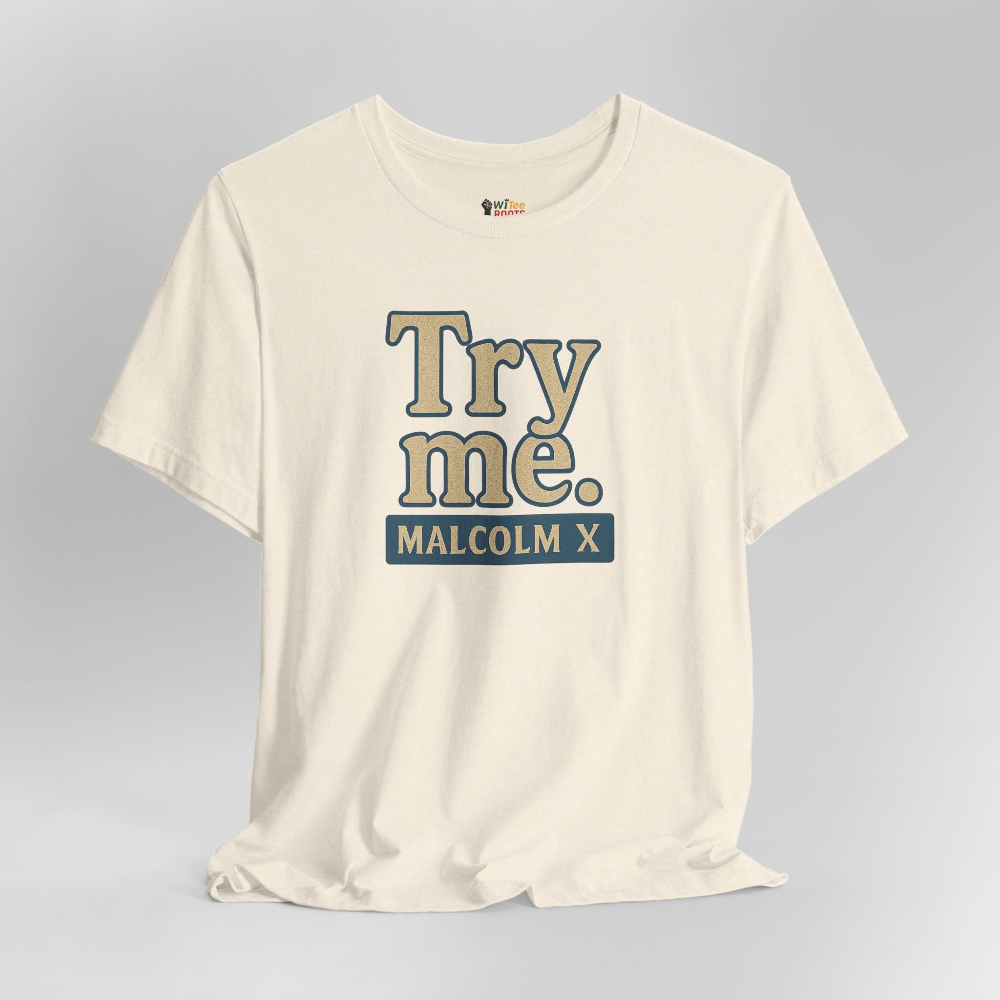 White t-shirt with 'Try me. Malcolm X' text on a gray background