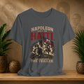 Gray t-shirt with historical graphic and text on a wooden surface with plants and decorative items.
