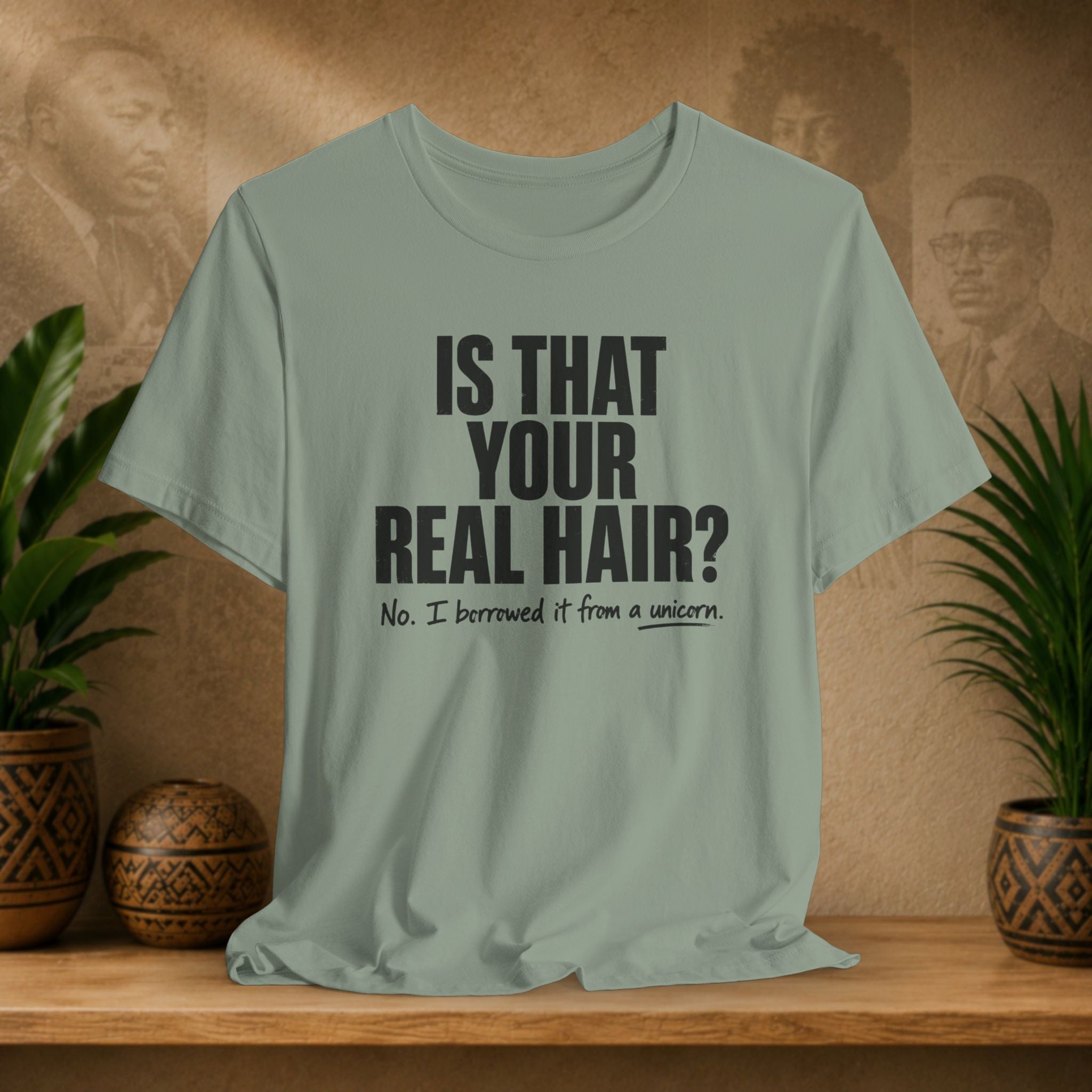 Light green t-shirt with humorous text on a wooden surface with plants and a decorative item.