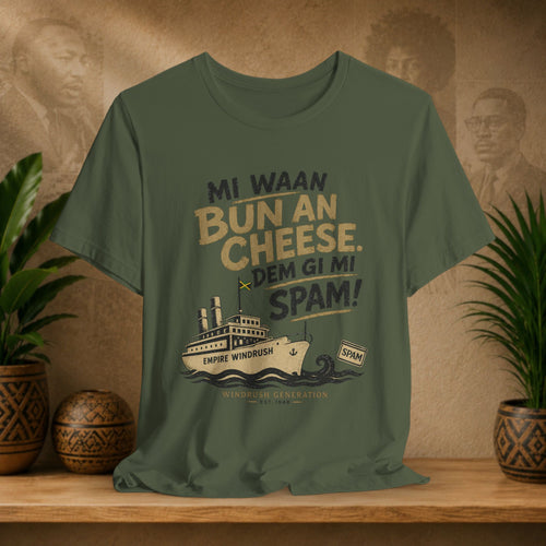 Green t-shirt with a graphic and text on a wooden surface with plants and a decorative wall.