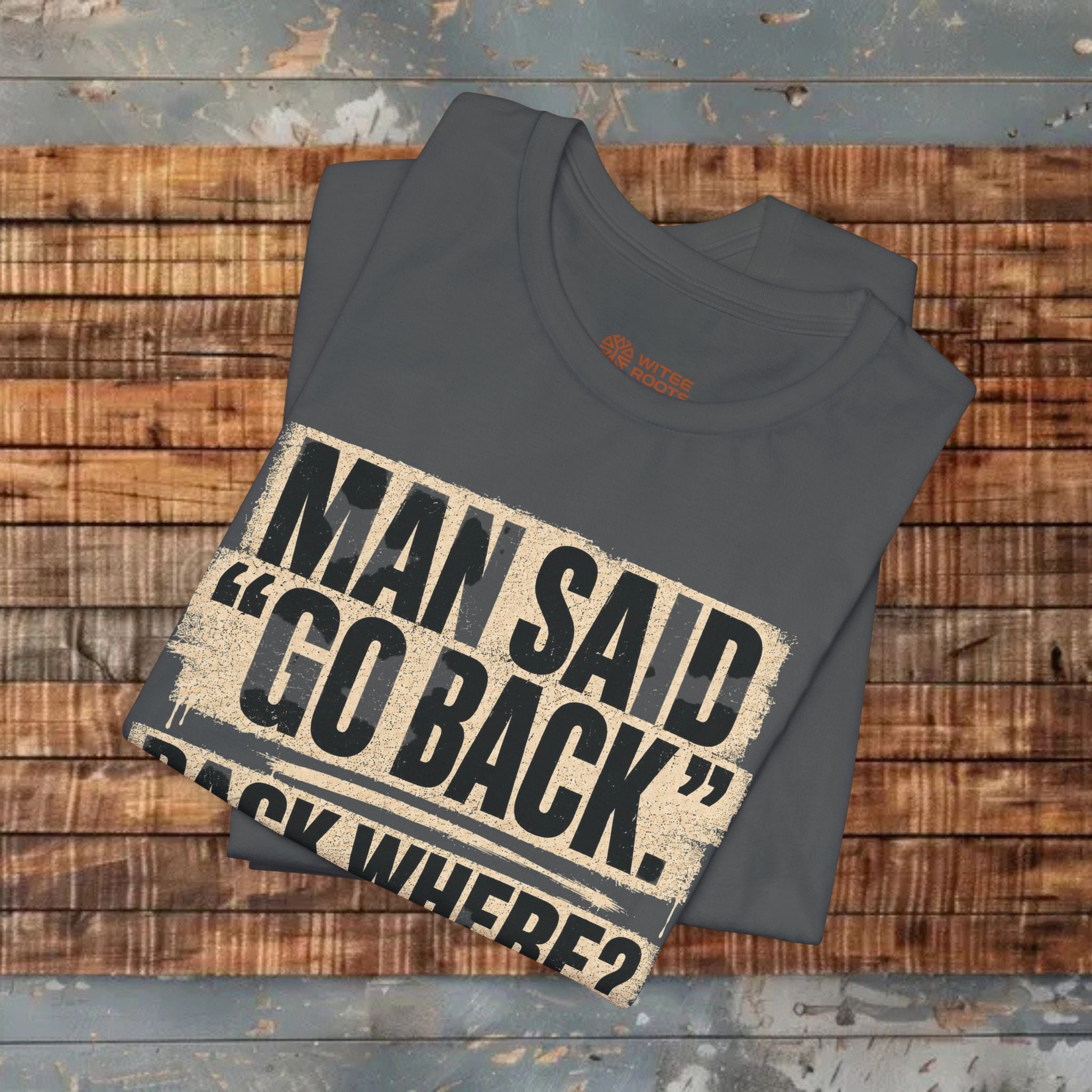 Folded gray t-shirt with a graphic design on a wooden surface