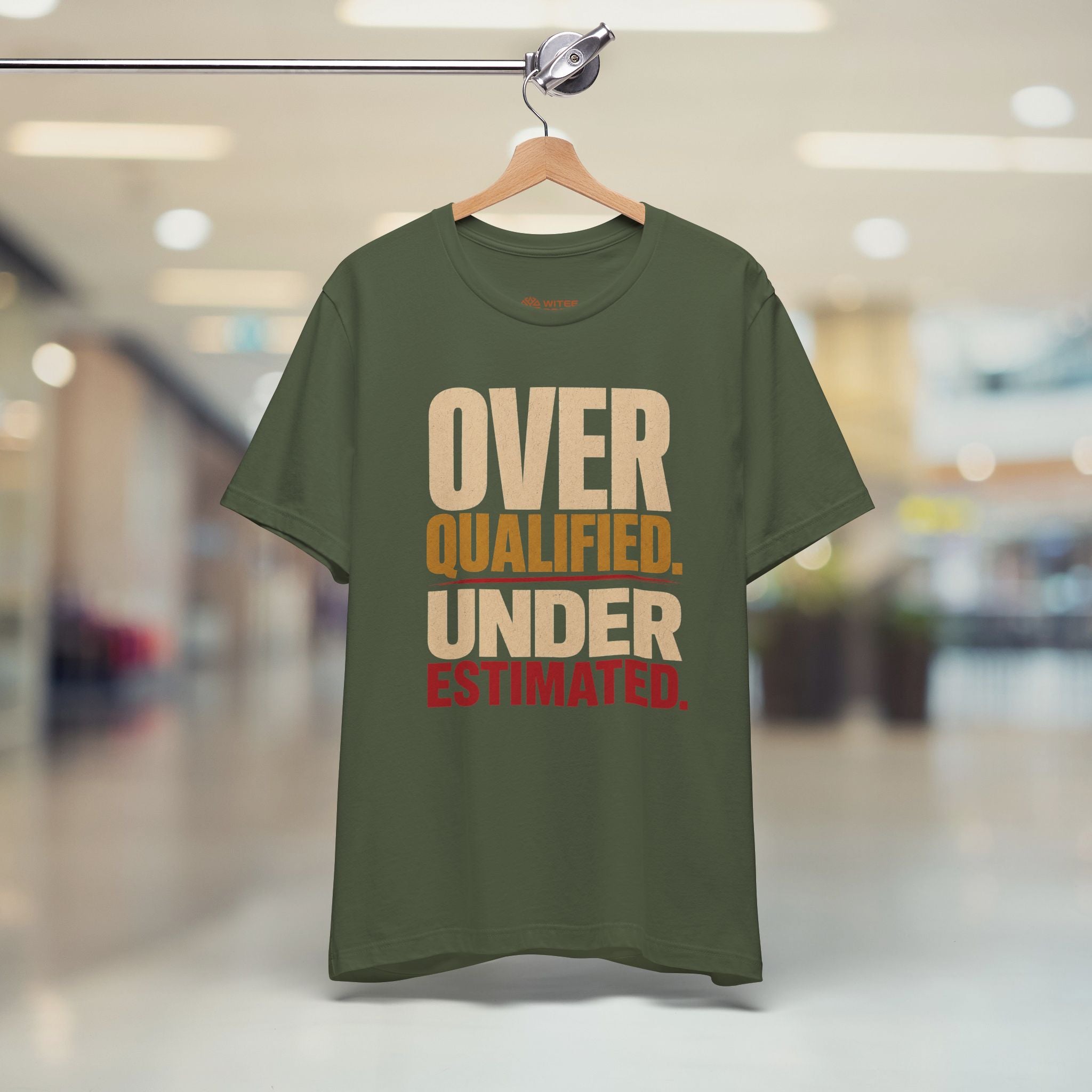Green t-shirt with text on a hanger in a store setting