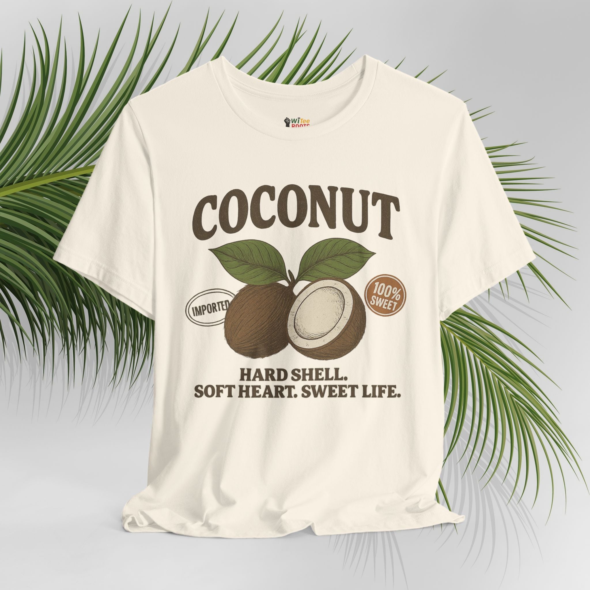 Cream t-shirt with coconut graphic and text on a light gray background with green leaves.