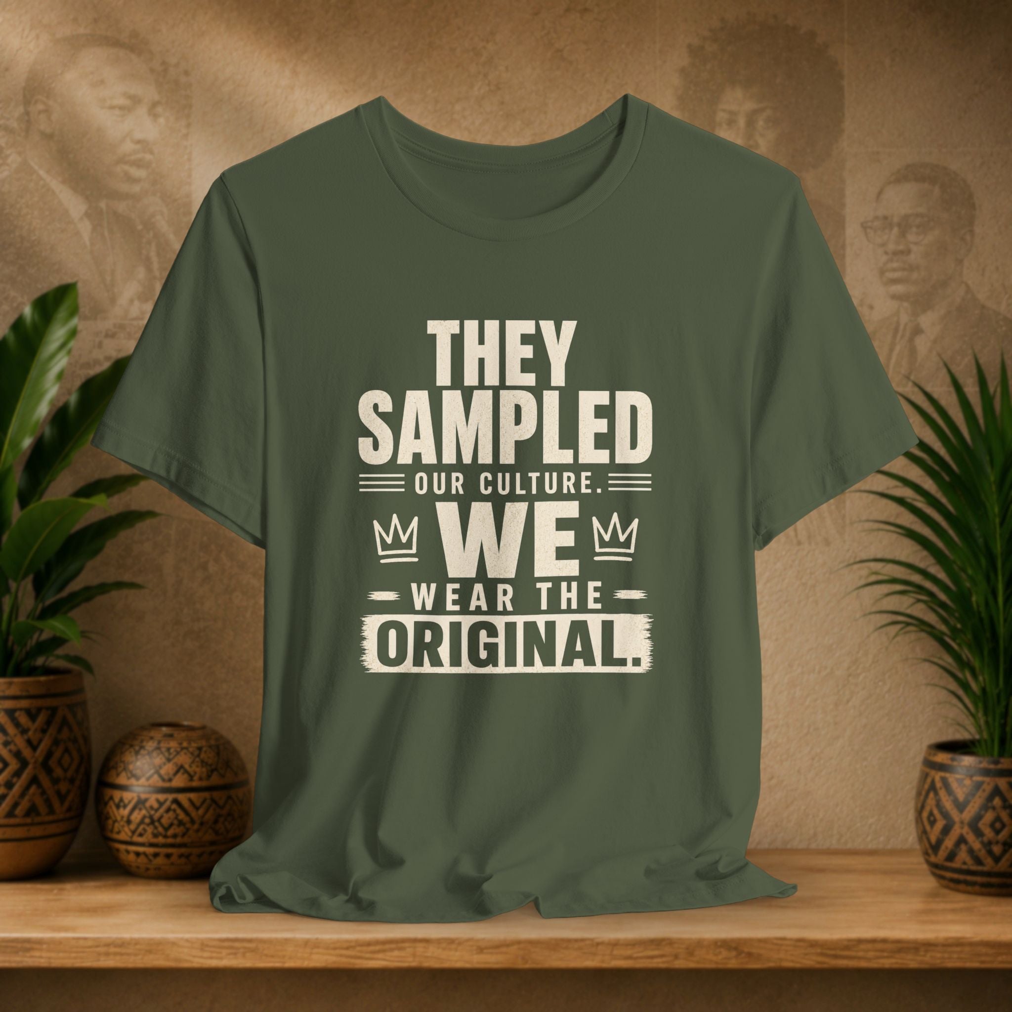 Green t-shirt with text on a wooden surface with plants and a textured wall background