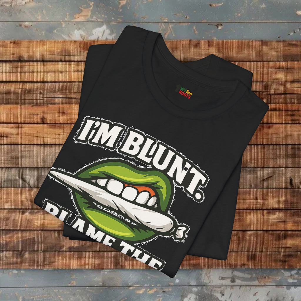 Black t-shirt with graphic design and text on a wooden surface