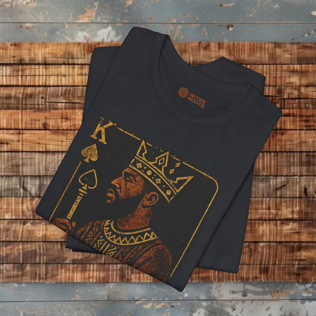 Black t-shirt with King of Hearts design on a wooden surface