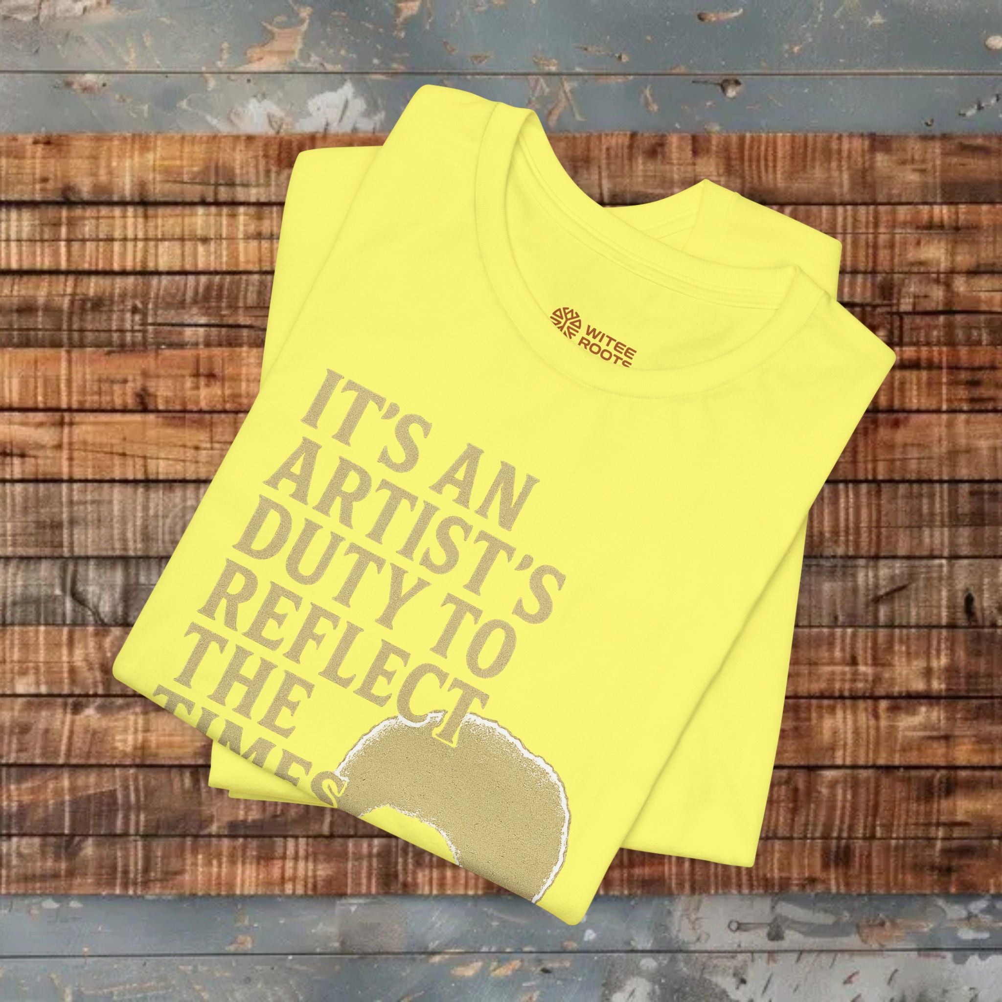 Yellow t-shirt with text on a wooden surface