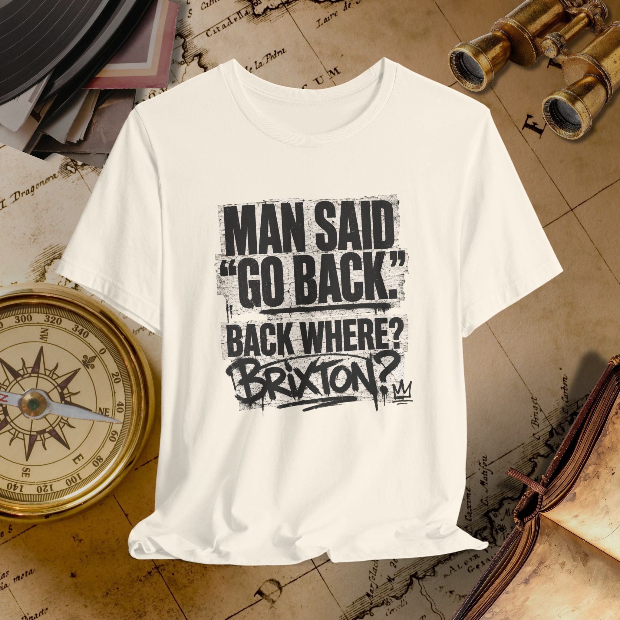 Beige t-shirt with black text on a vintage map background