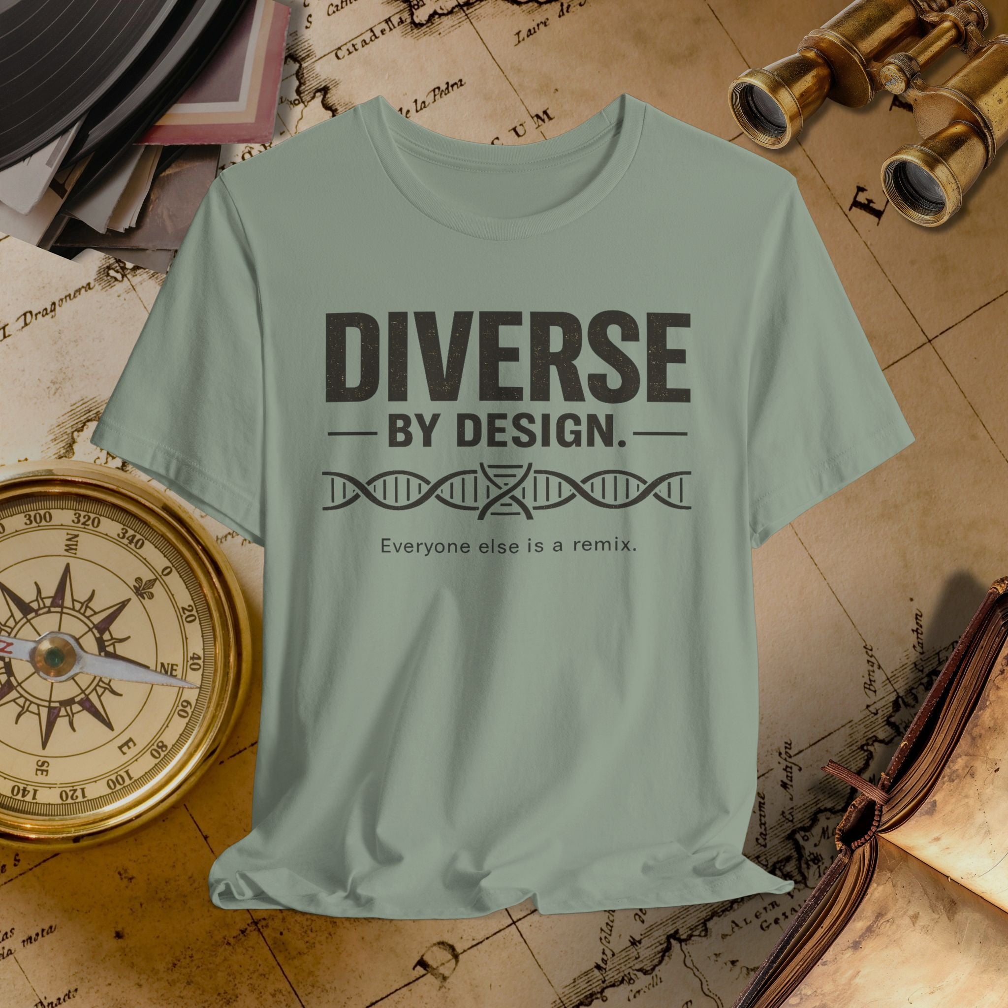 Light green t-shirt with 'Diverse by Design' text on a vintage map background