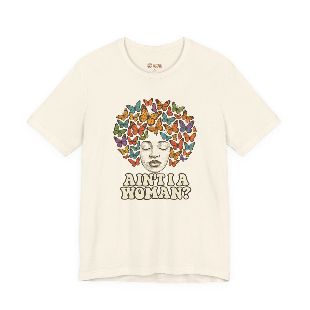 An off-white short-sleeve t-shirt with a graphic print of a face surrounded by colorful butterflies, with the text 'AINT A WOMAN?' below it.