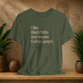 A military green graphic t-shirt with the text 'I like Black folks And maybe 3 other people.' printed in a light beige sans-serif font.