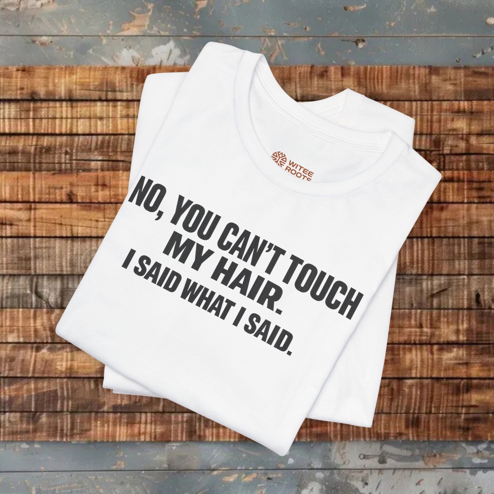 White t-shirt with text on a wooden surface