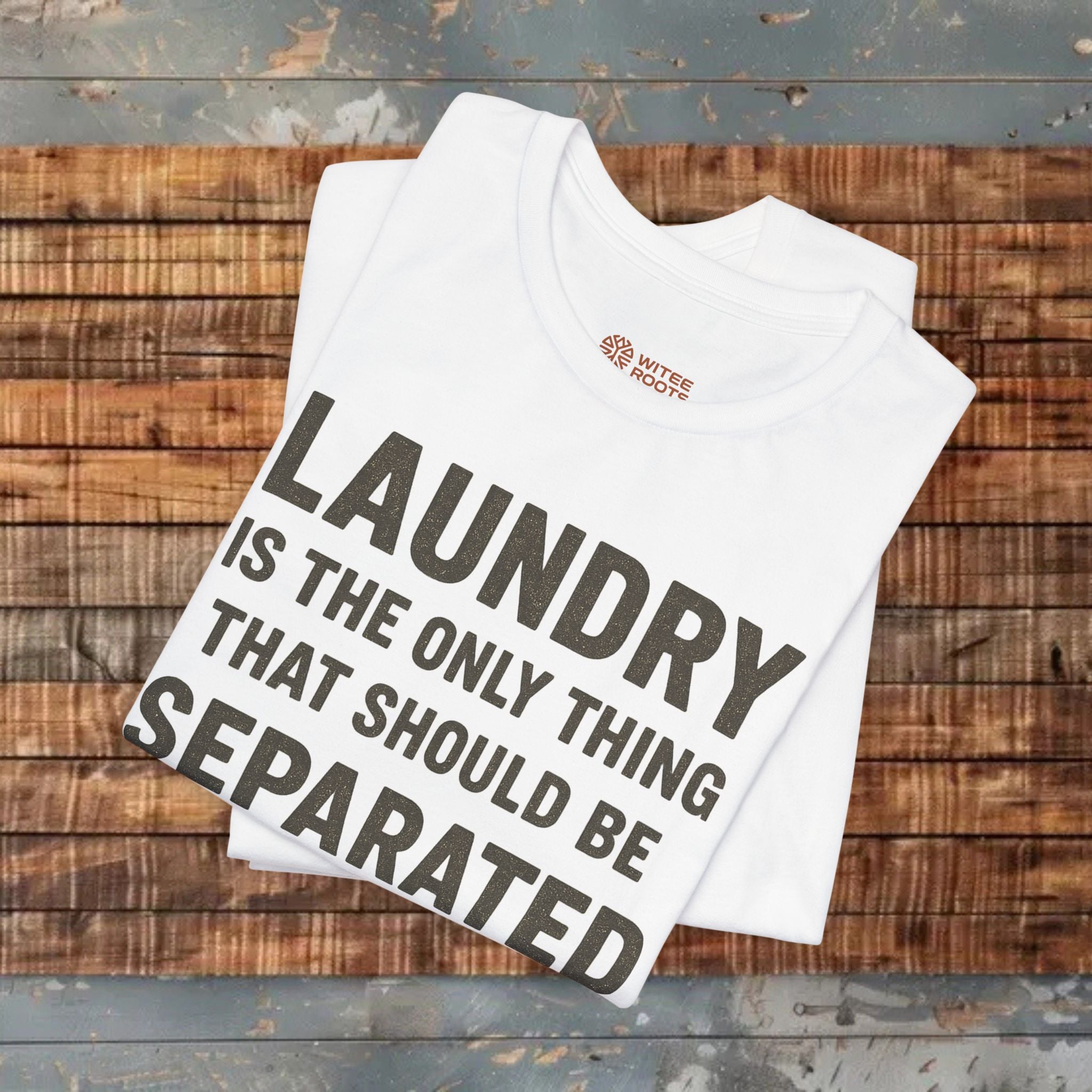 White t-shirt with humorous text design on a wooden surface