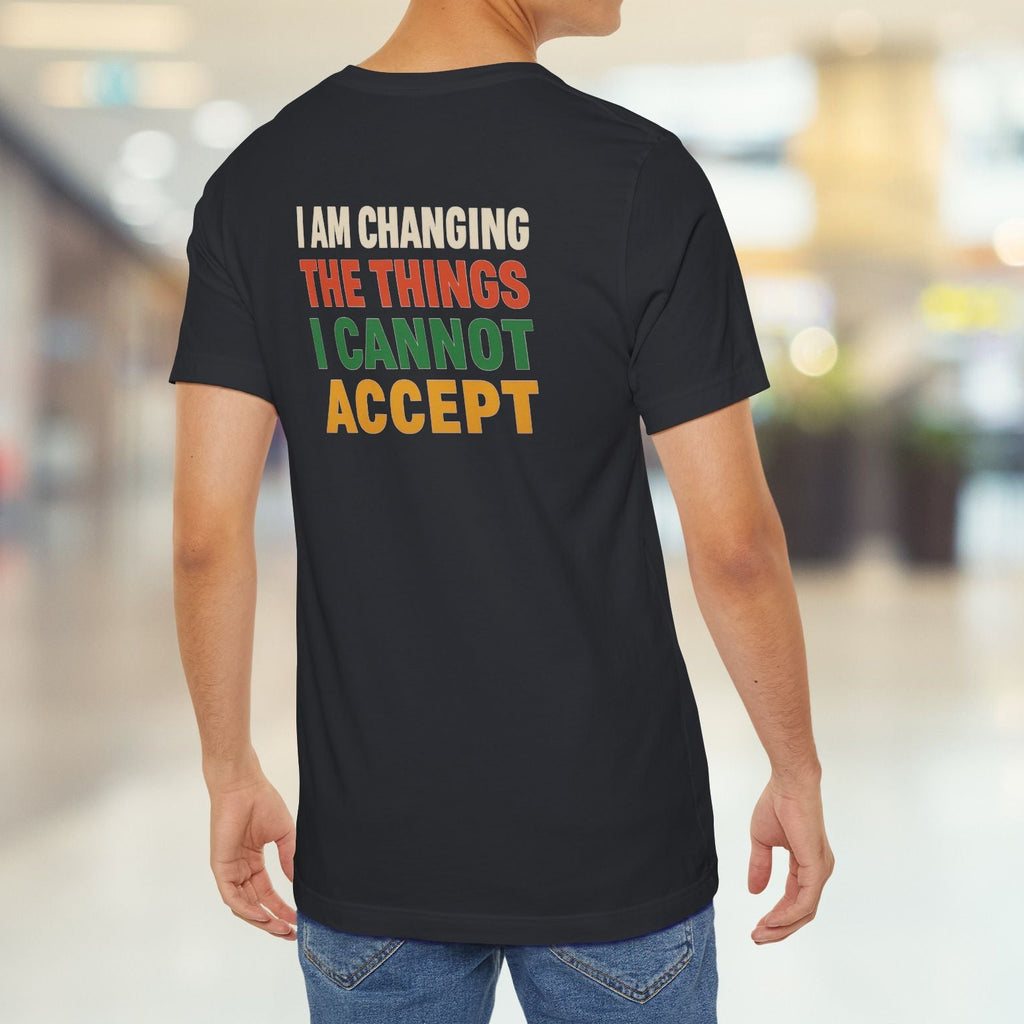 Person wearing a black t-shirt with a motivational message in colorful letters.