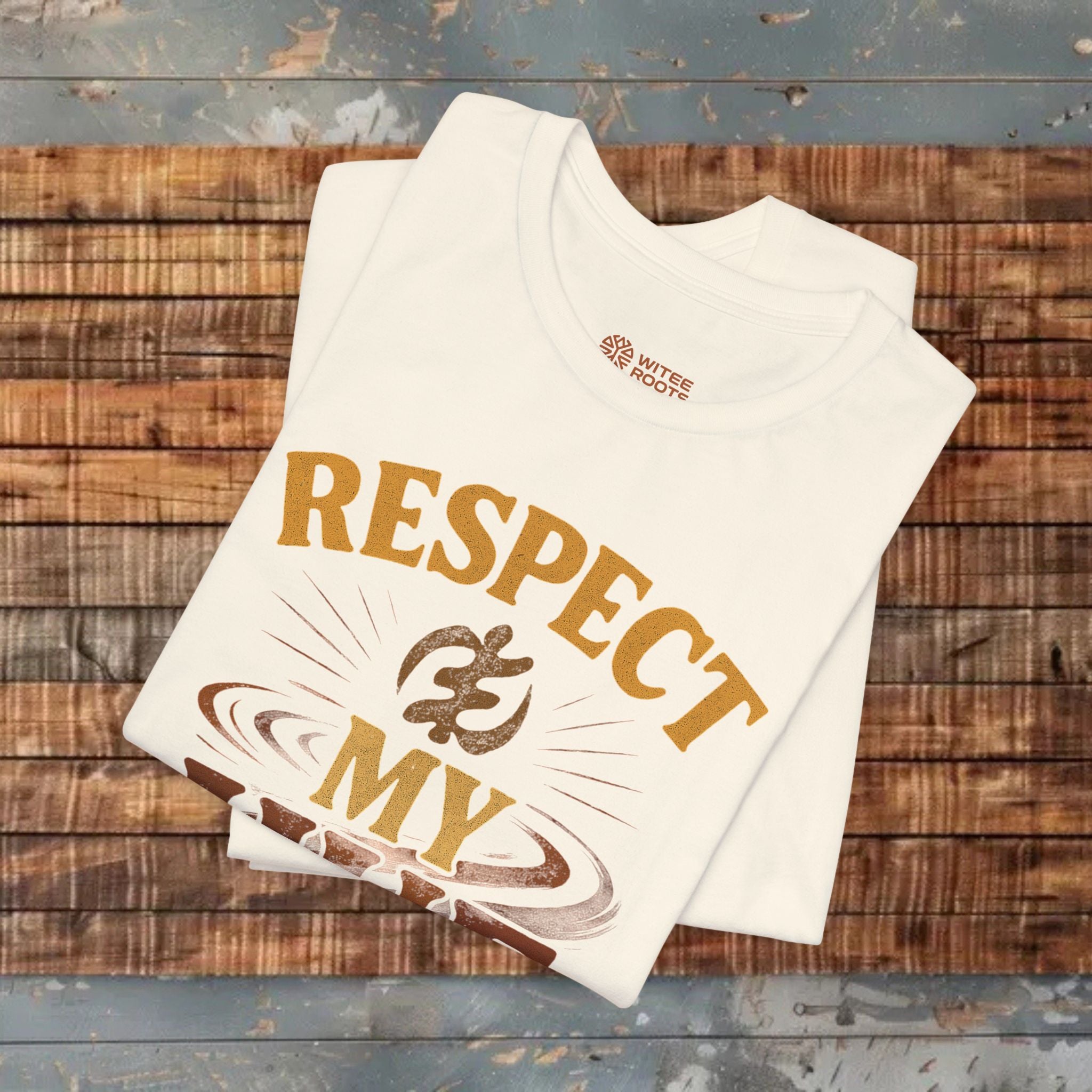 Cream t-shirt with 'RESPECT MY' design on a wooden surface