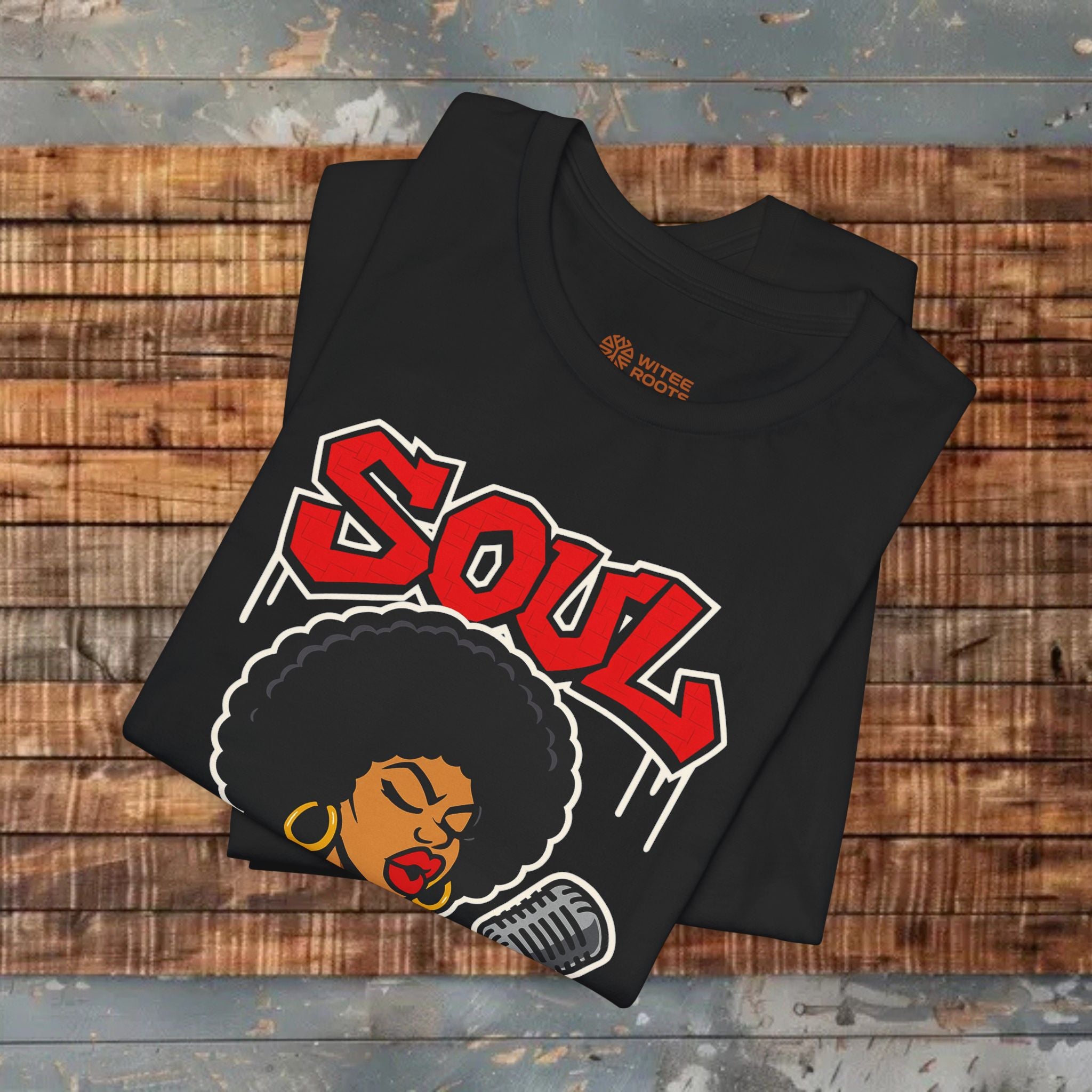 Black t-shirt with 'SOUL' design on a wooden surface