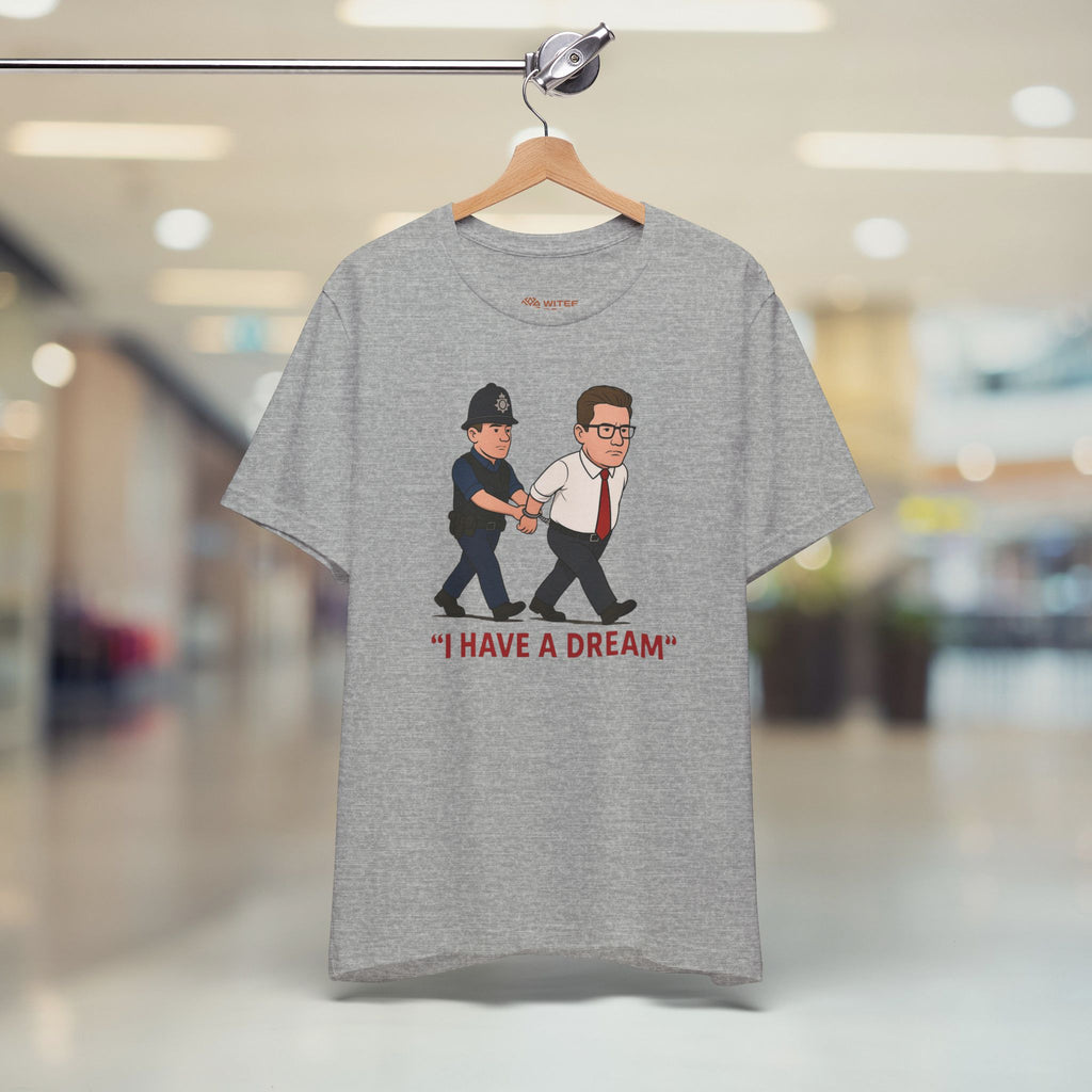 Gray t-shirt with graphic design of two men being arrested and 'I HAVE A DREAM' text, hanging in a store.