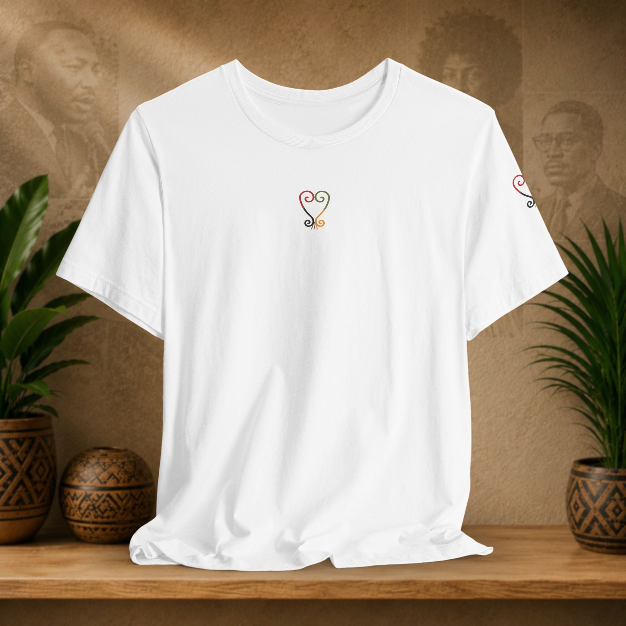 White t-shirt with a black symbol on a wooden shelf with plants and a textured wall background
