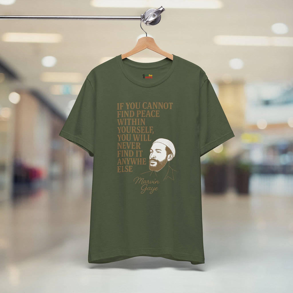 Green t-shirt with a motivational quote and a face on a hanger in a store.