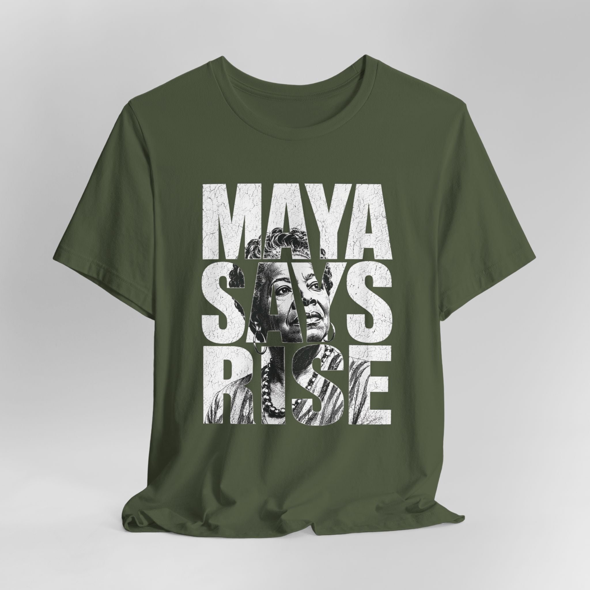 Green t-shirt with 'Maya Says Rise' text and graphic on a gray background