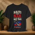 Black t-shirt with political graphic and text on a wooden surface with plants and decorative items.