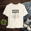 Beige t-shirt with 'WITEE ROOTS' text design on a wooden surface with jeans and sneakers.