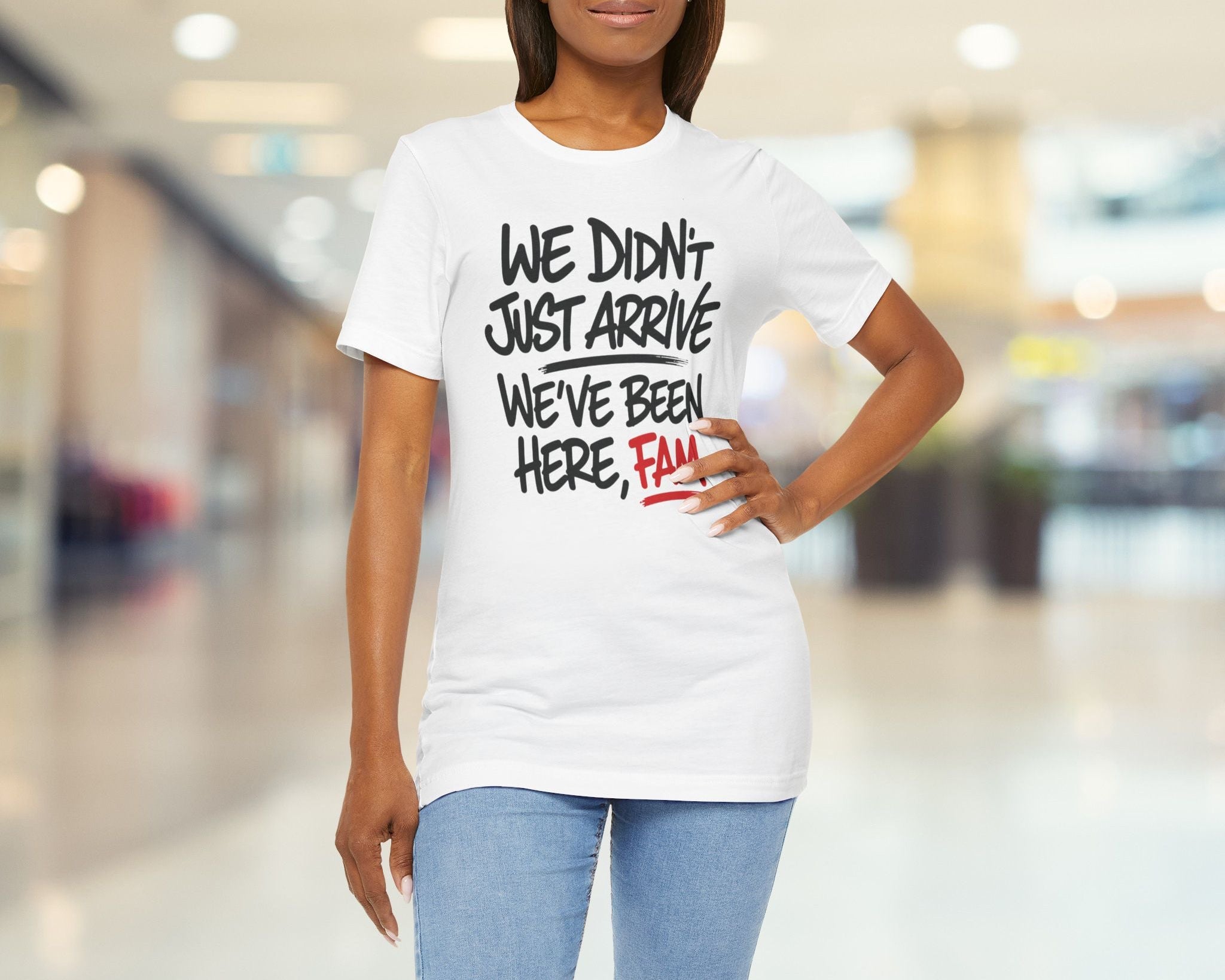 Woman wearing a white t-shirt with humorous text in a blurred indoor setting