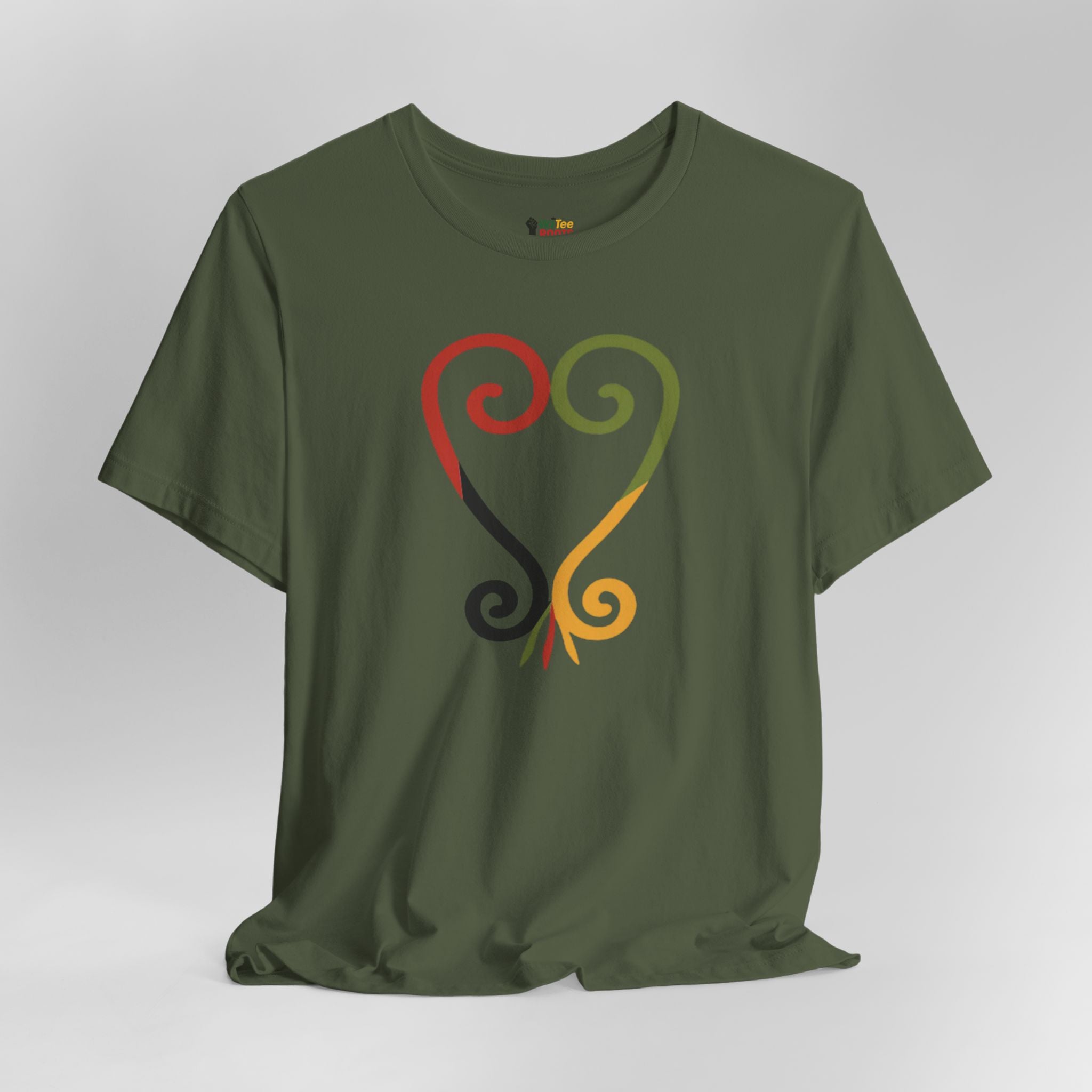 Green t-shirt with colorful abstract design on a gray background