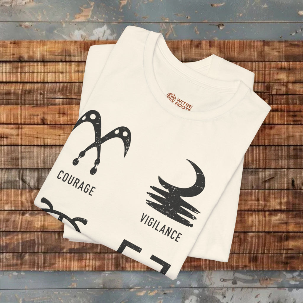 Two folded T-shirts with Adrinka symbols and text on a wooden surface