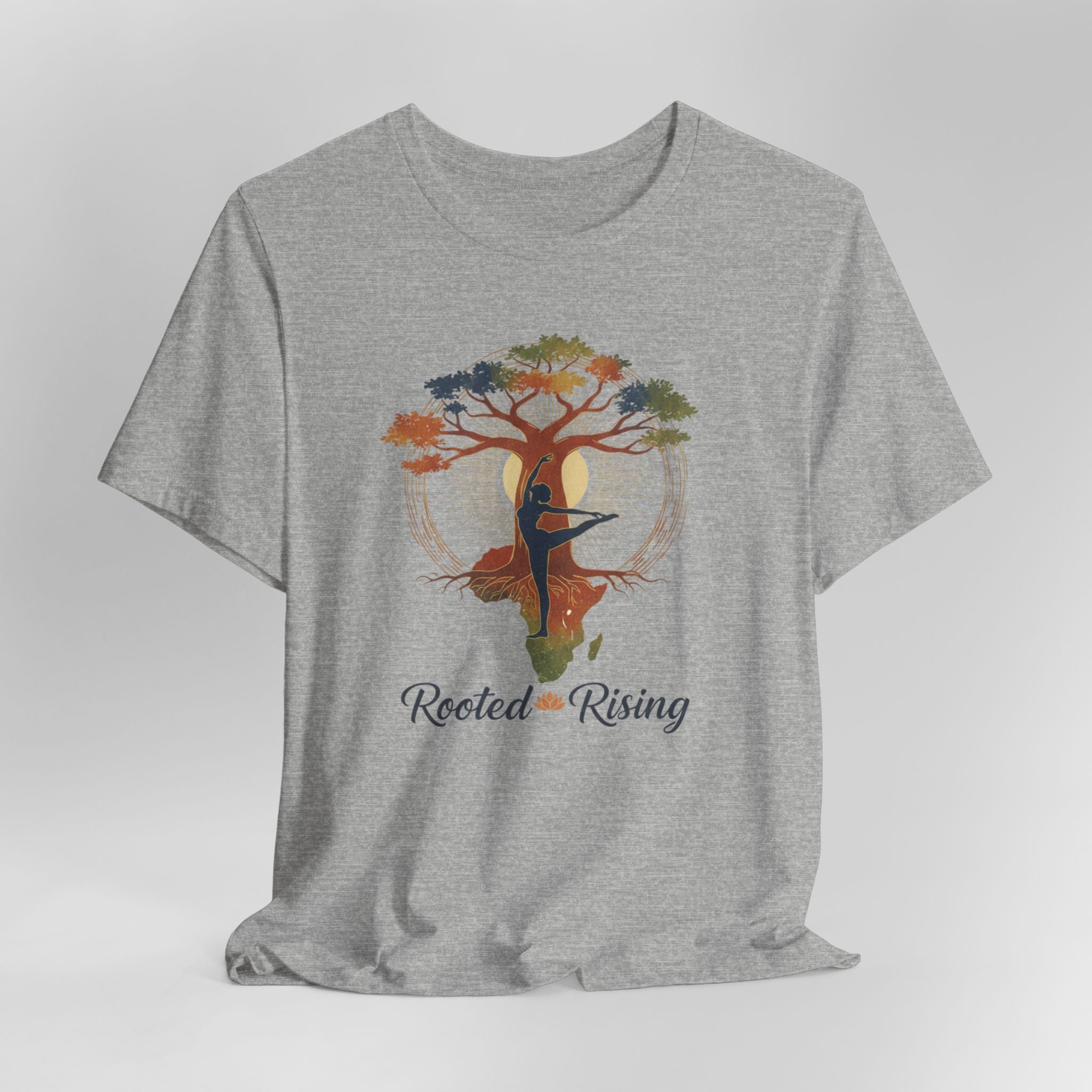 Gray t-shirt with a colorful tree and dancer graphic and 'Rooted Rising' text on a light gray background