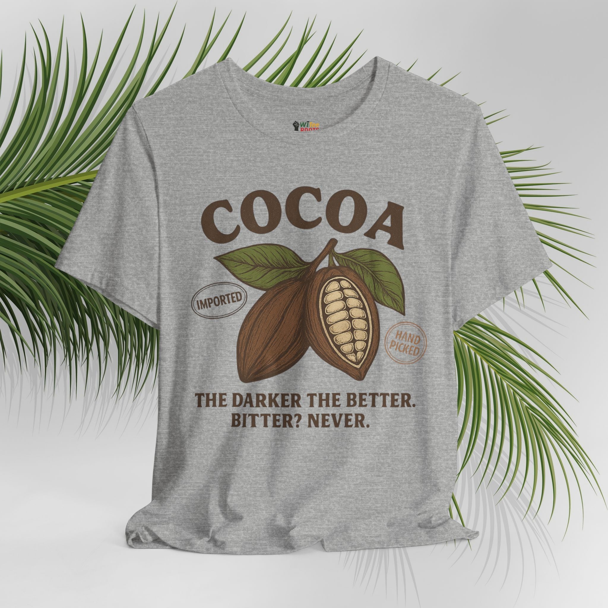 Gray t-shirt with cocoa graphic and text on a white background with green leaves.