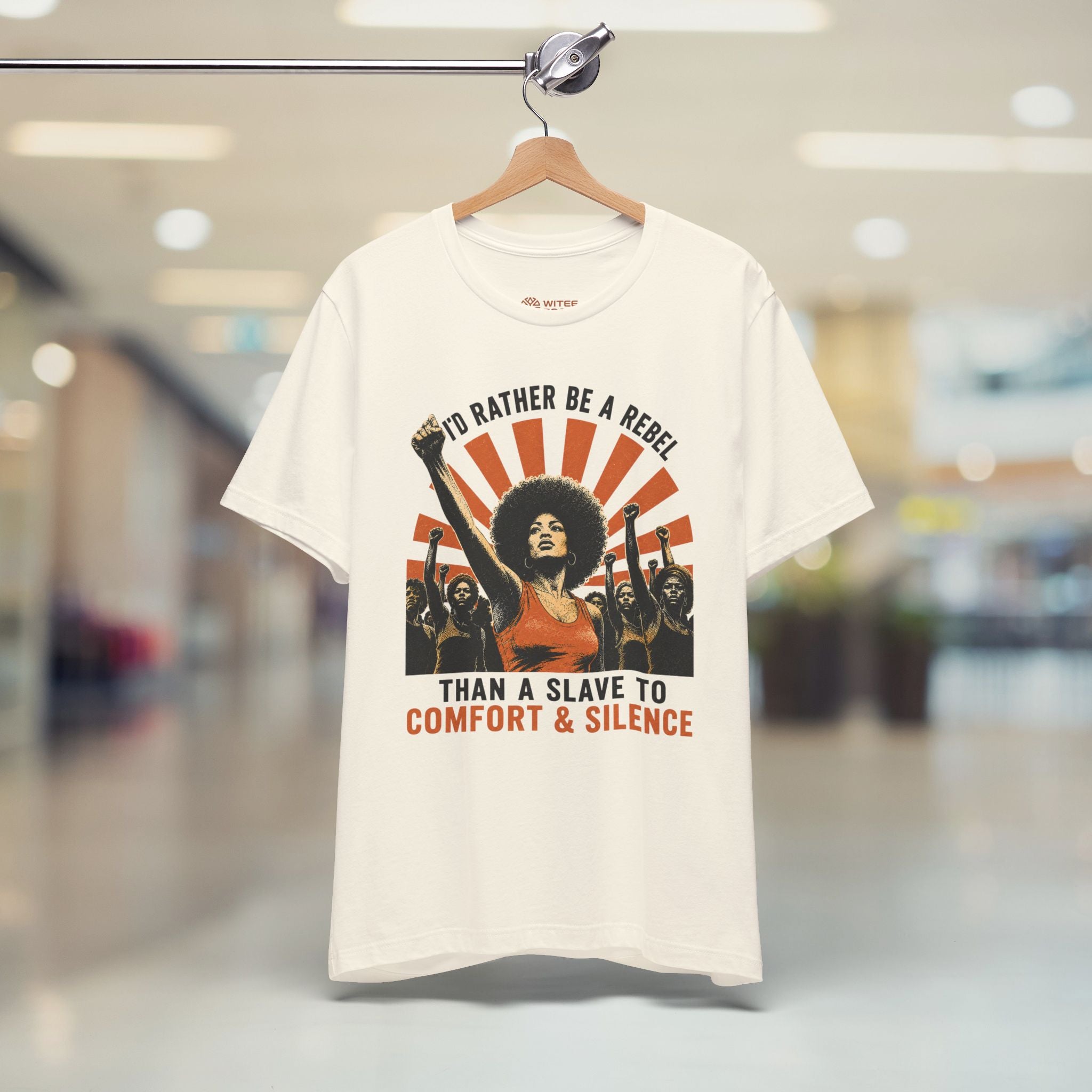 White t-shirt with graphic design and text on a hanger in a store setting