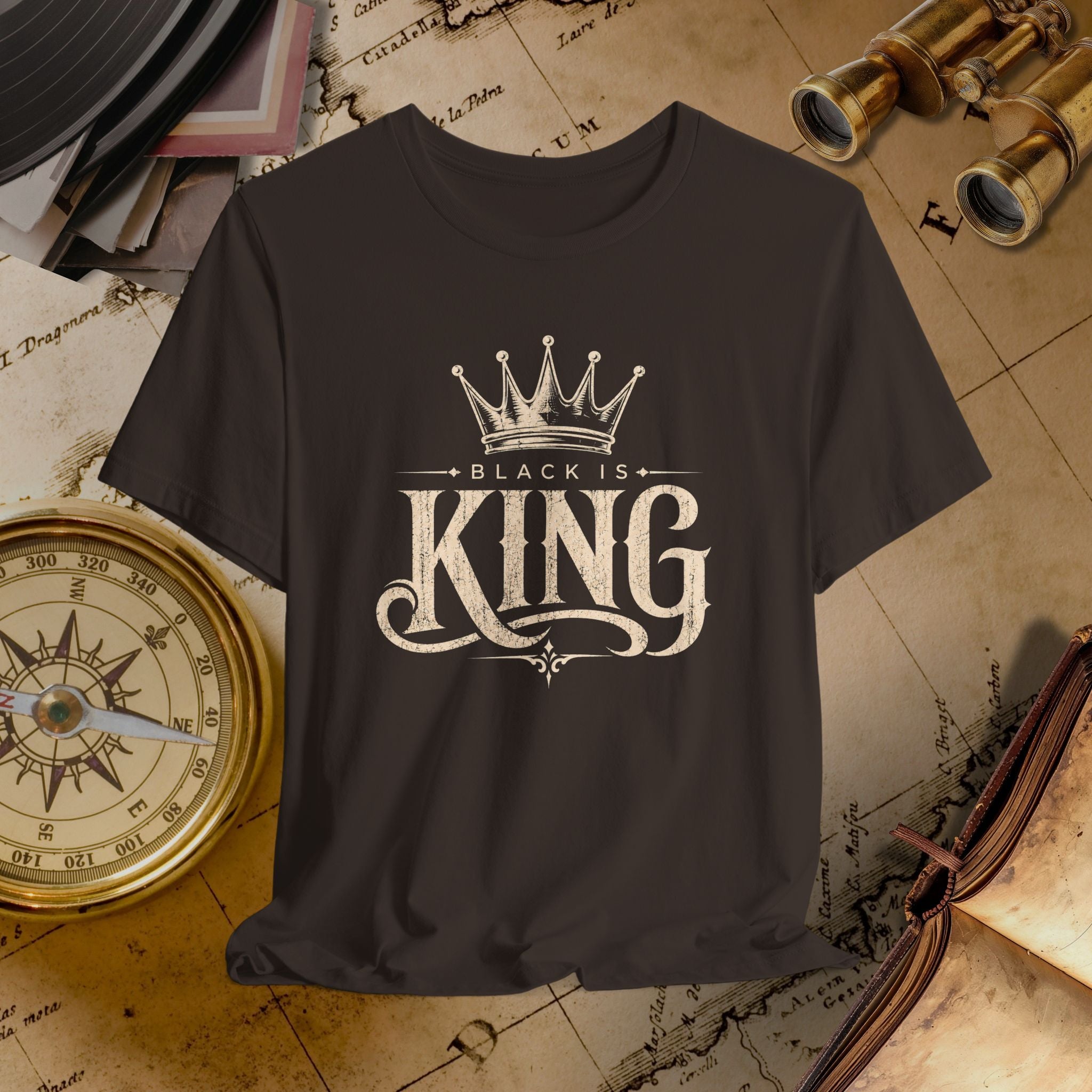 Brown t-shirt with 'Black is King' design on a vintage map background