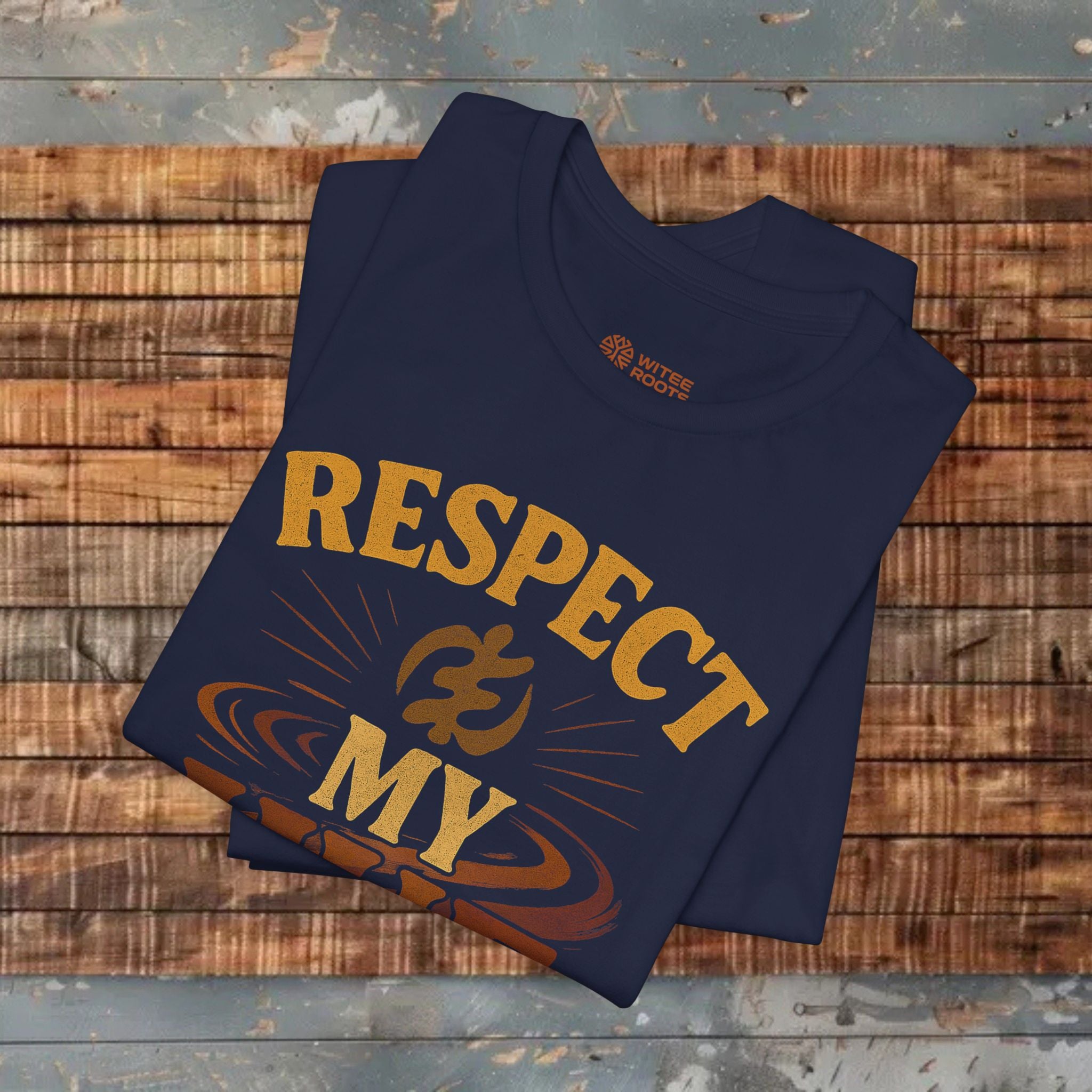 Folded navy blue t-shirt with 'RESPECT MY' text on a wooden surface
