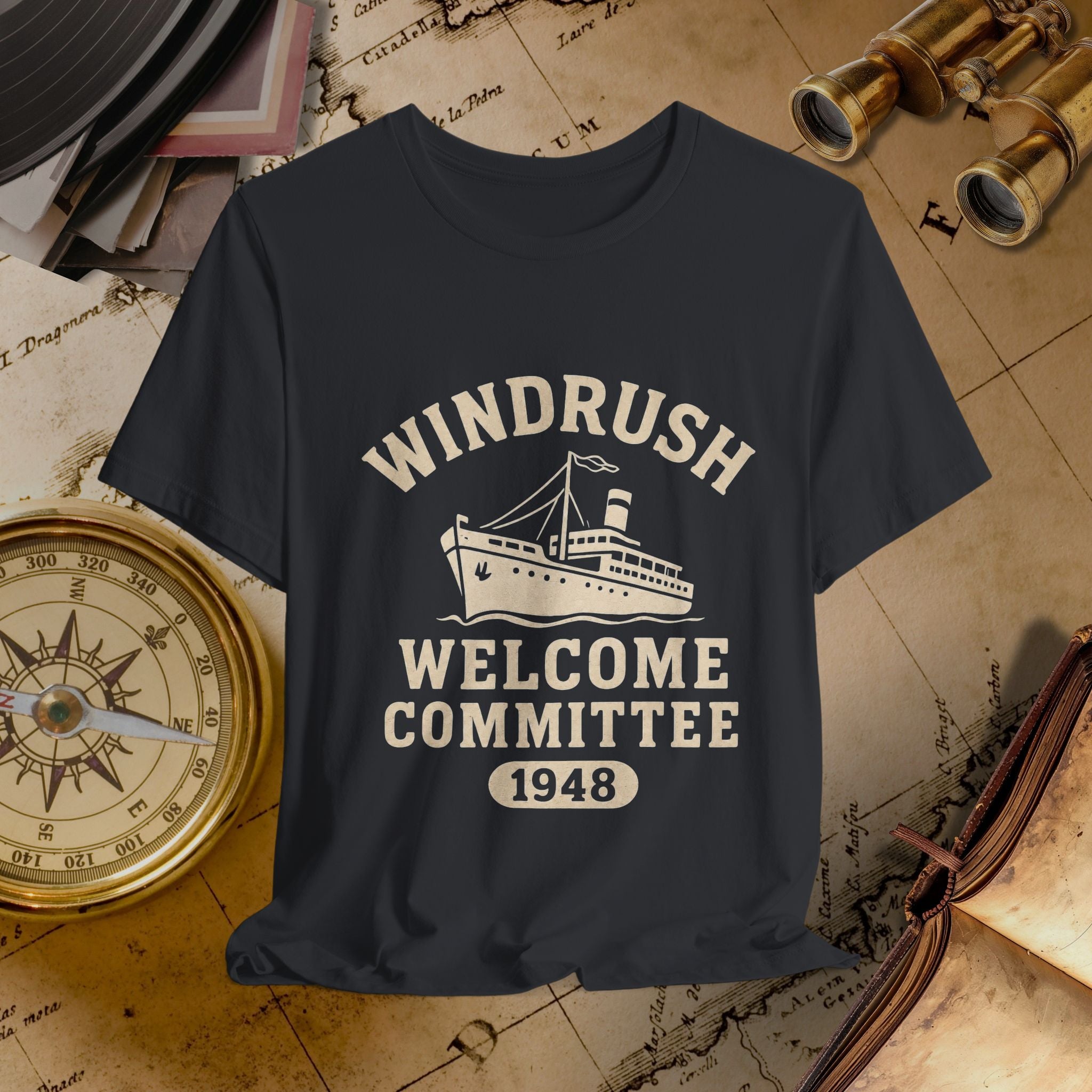 Black t-shirt with 'Windrush Welcome Committee 1948' design on a vintage map background.