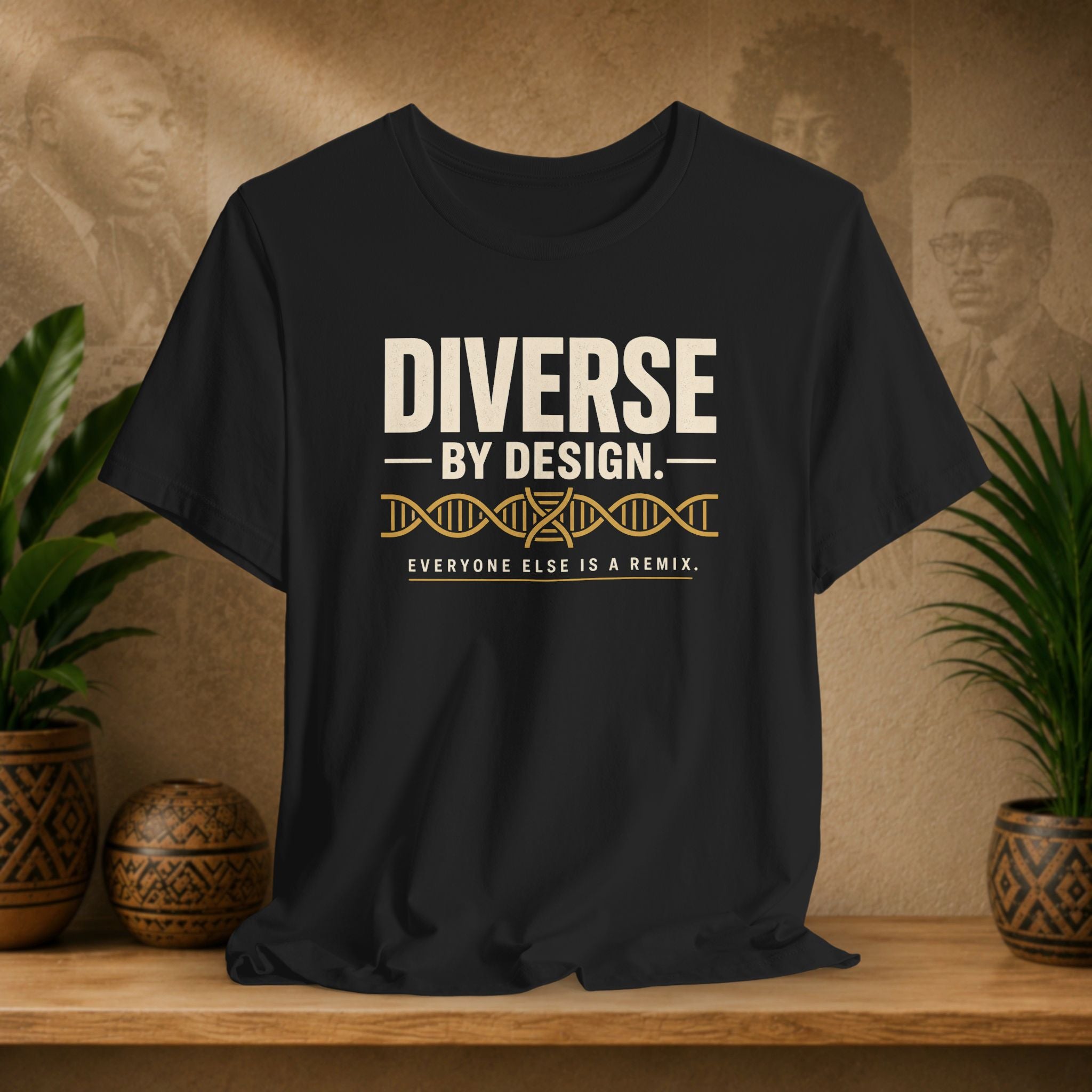 Black t-shirt with 'Diverse by Design' text on a wooden surface with decorative items in the background