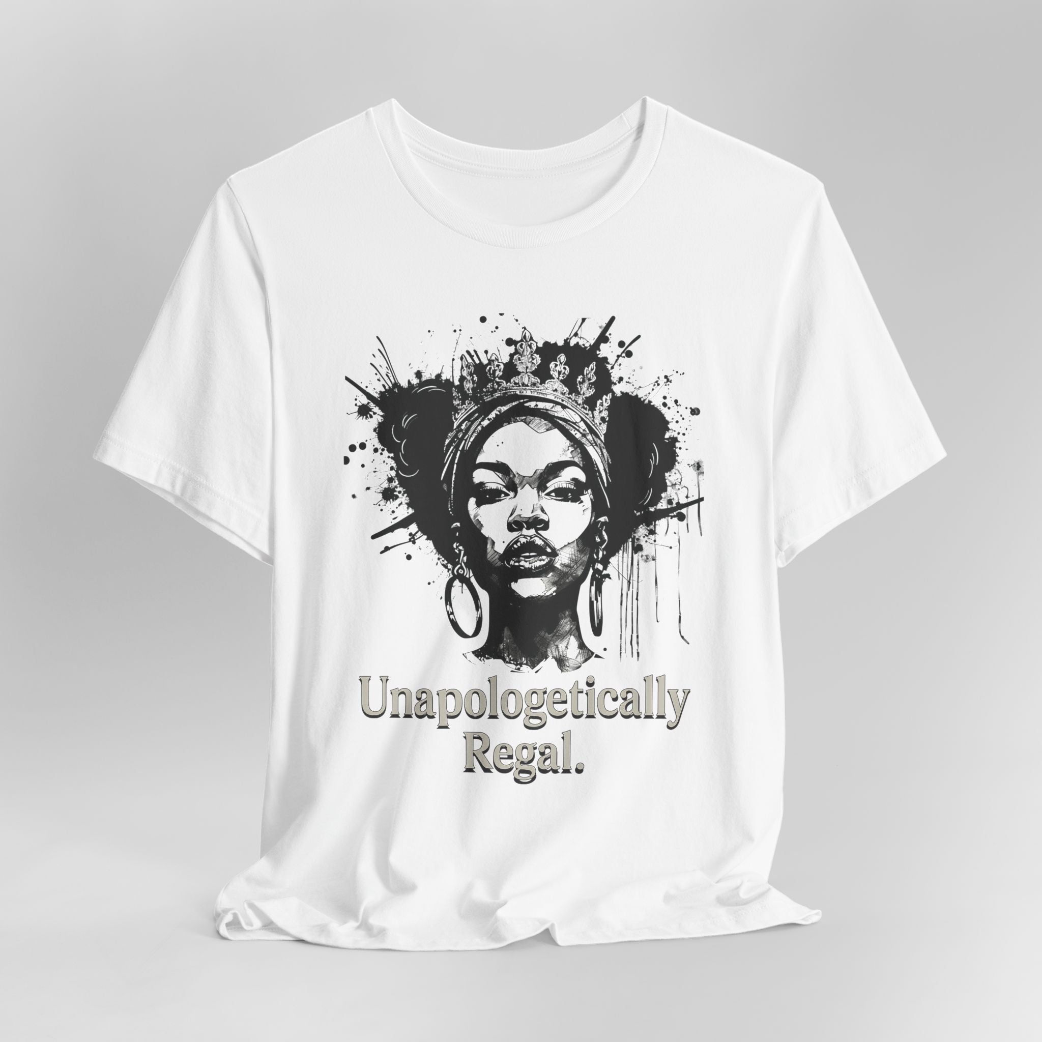 White t-shirt with a graphic of a woman's face and the text 'Unapologetically Regal' on a gray background