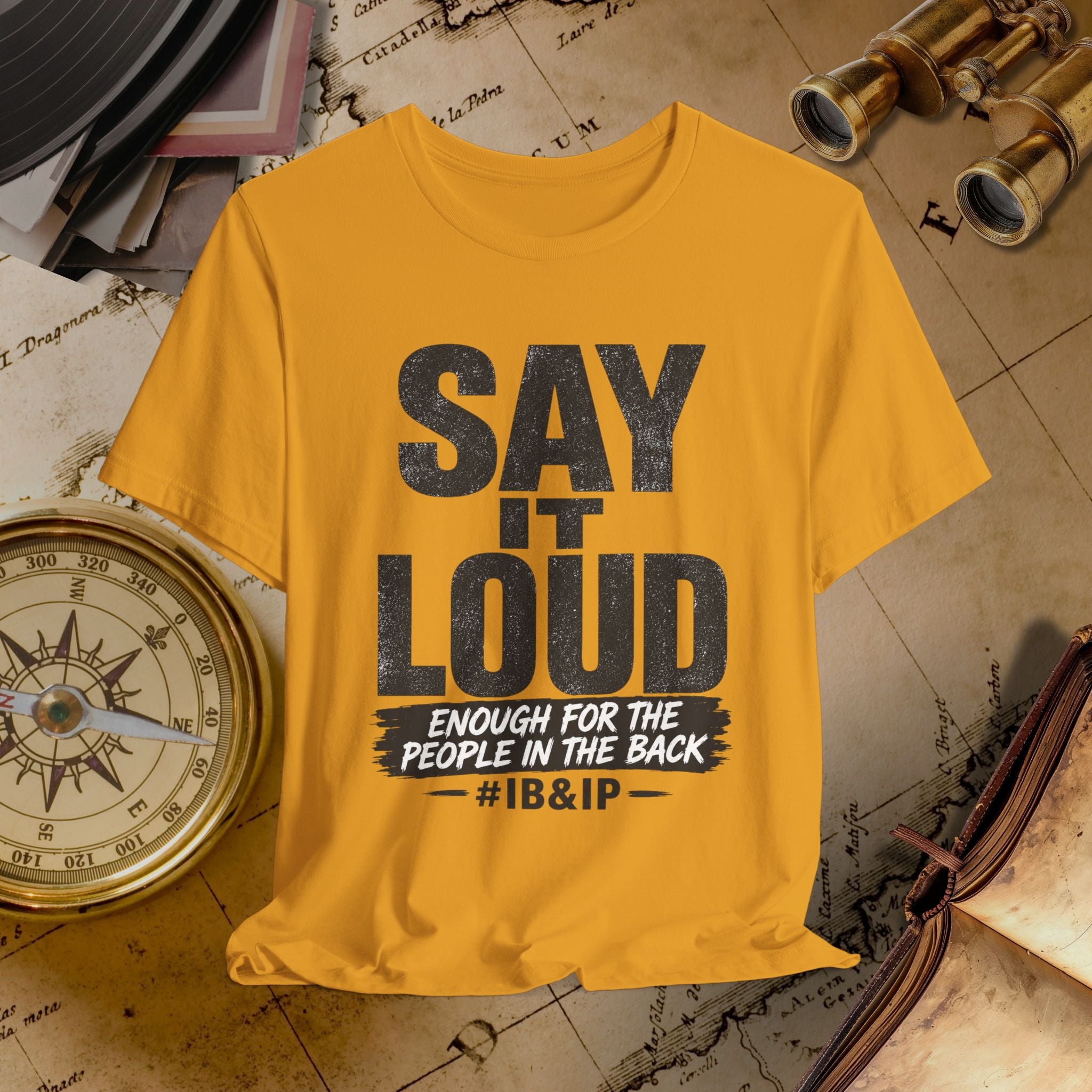 mustard t-shirt with 'Say it Loud' text on a vintage map background